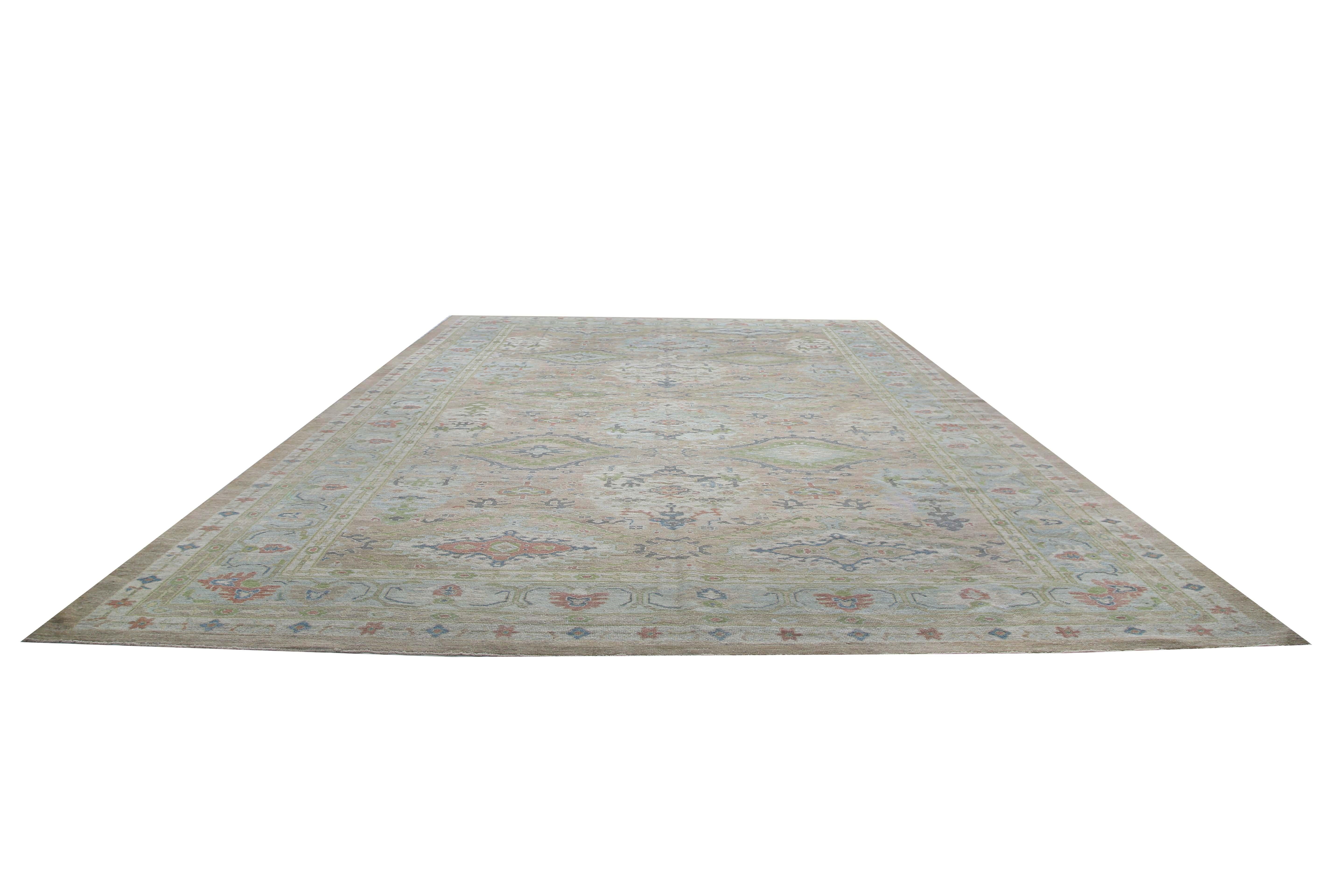 Looking for a statement piece to tie your room together? Look no further than this stunning Turkish Sultanabad rug! Measuring 12'4'' by 18'8'', this rug boasts a beige background with colorful design elements, including green, red, and light blue.