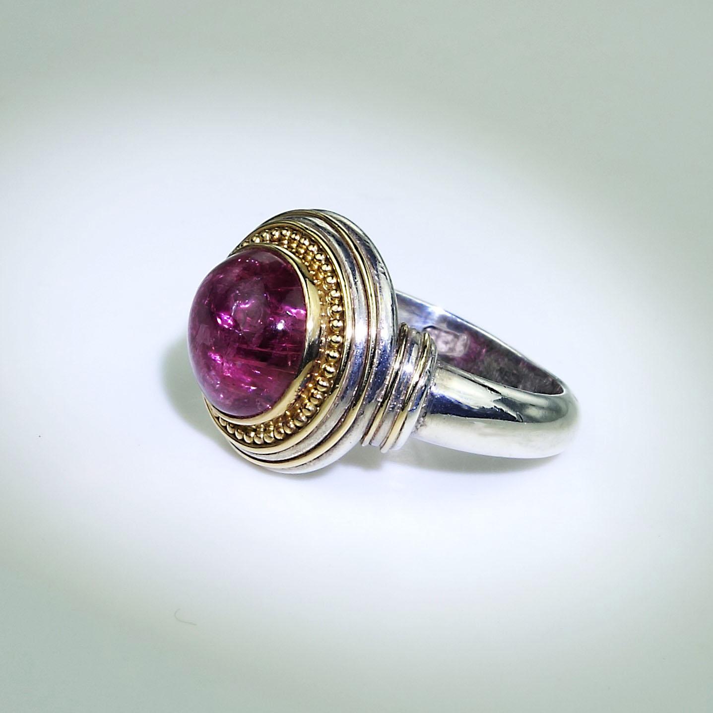 Gorgeous Round Pink Tourmaline Cabochon bezel set in 18K yellow gold with beaded accents set in a Sterling Silver ring.  A Steven Battelle ring.  The sparkling Pink Tourmaline Cabochon has the typical inclusions which increase the sparkle.  Size 7
