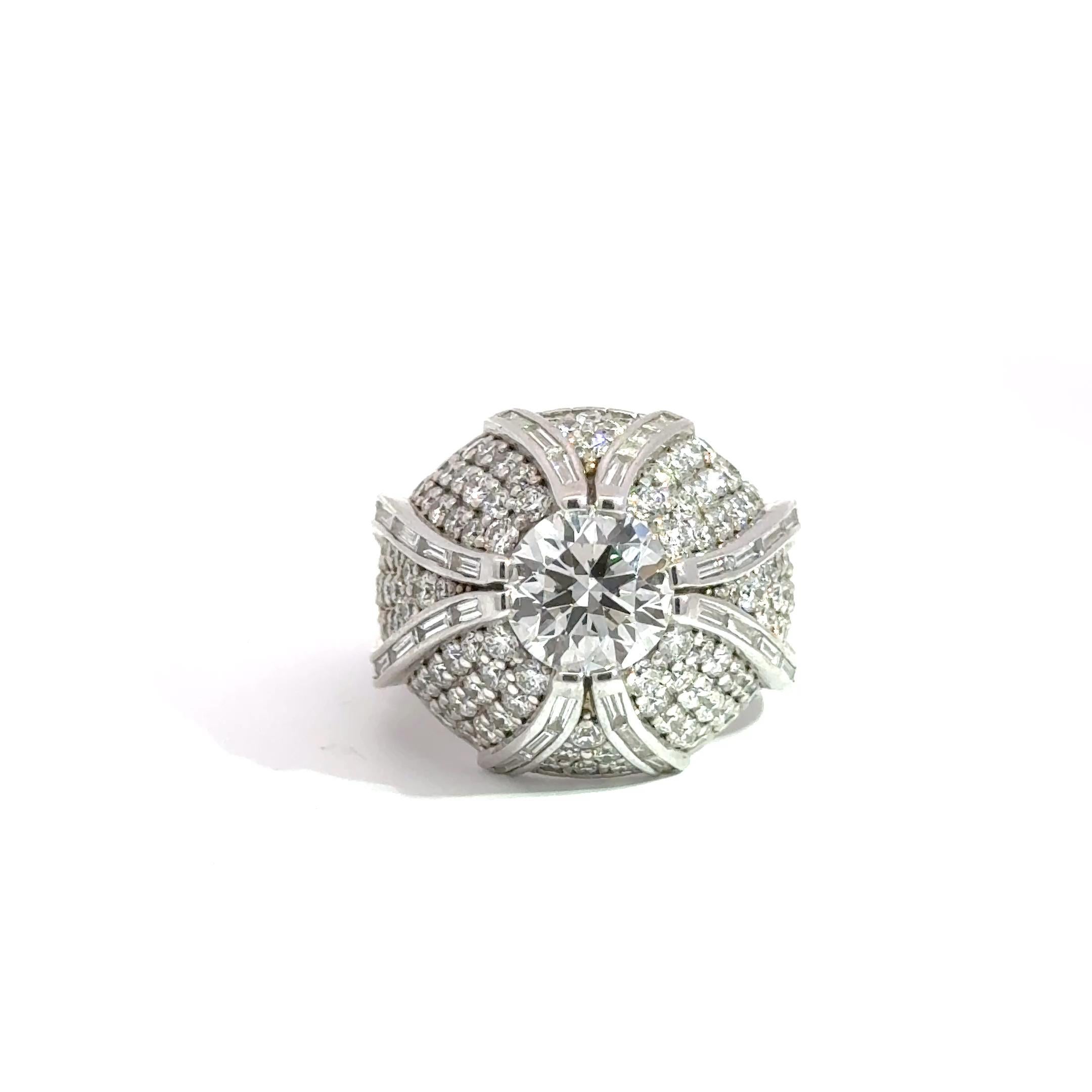 Unapologetically bold and undeniably luxurious, this high-impact cocktail ring is crafted in rich 14k white gold and showcases a GIA 2.05-carat G-VS2 round brilliant center diamond. Radiating from the center are ribbons of channel-set baguette