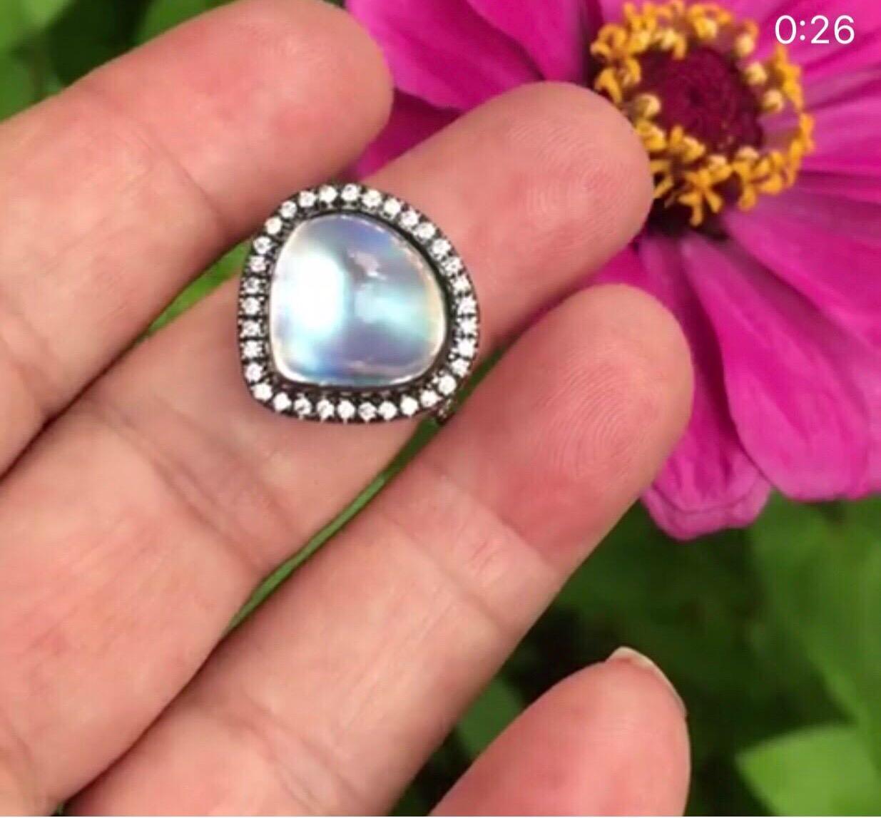 The Pear Shape Royal Blue Moonstone Is Set in 18 K White Gold, Accented By White Diamonds, Black Rhodium Plated. Stone Origin is India, Where the Best Blue Moonstones Are Minded, The  Gem  Displays The  Strong Blue Primary  Color Additionally   Also