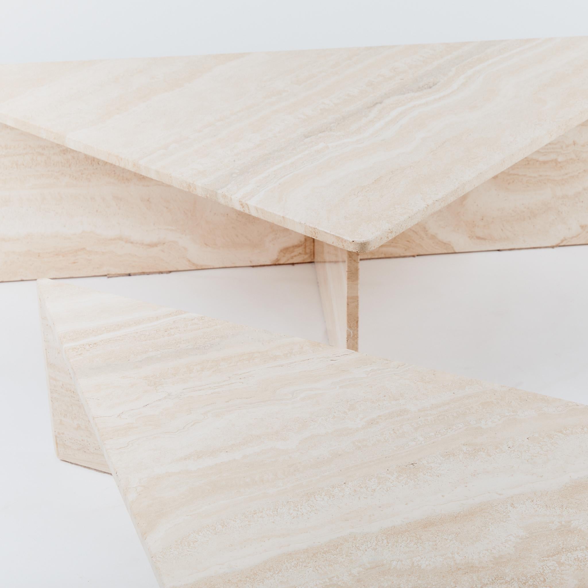 This statement coffee table consists of two triangular pieces with different heights which can be placed in a variety of positions. In pale tones the marble has a polished finish and has felt pads on the base to protect the piece.

Dimensions: