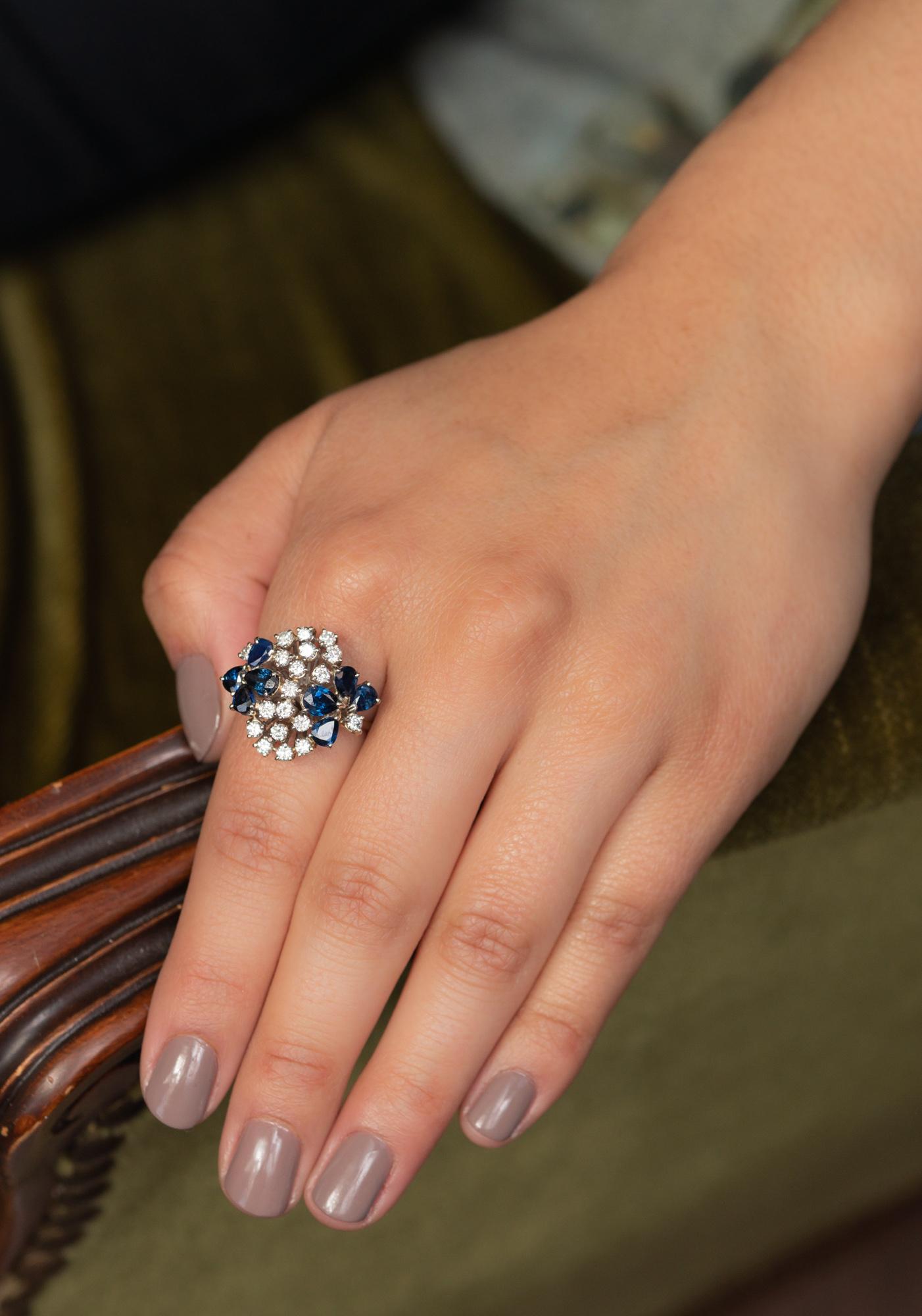 A statement diamond and sapphire ring with a whooping crown measuring 2.4 cm in diameter! 

An absolutely head-turning piece set with 19 brilliant cut diamonds of 0.1 CT each and 8 pear-shaped sapphires. The sapphires have a lovely deep-blue color