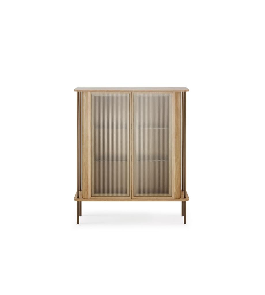 This contemporary display case is created with simplicity and longevity in mind. With two fluted glass doors and four shelves.