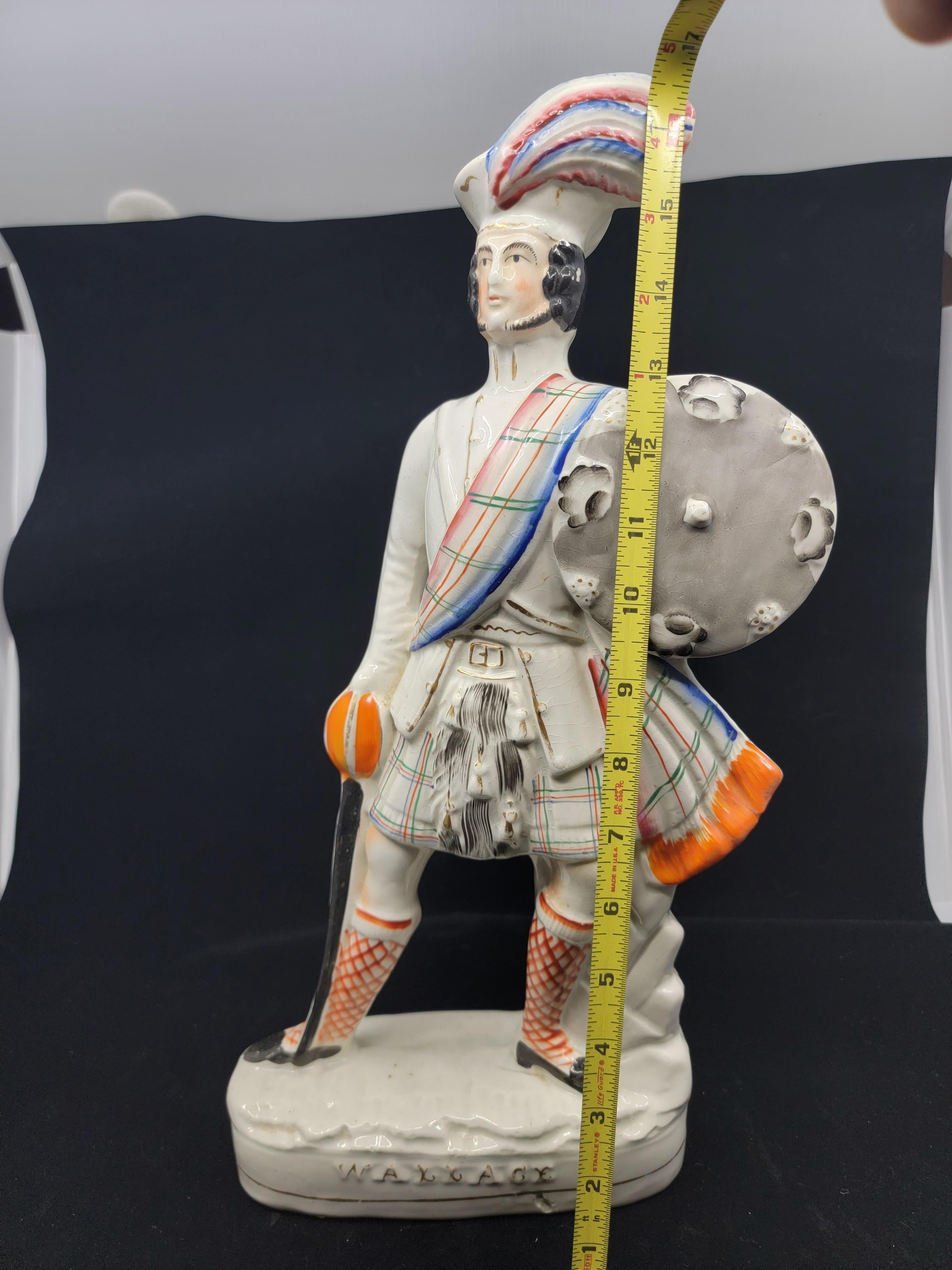 This military statue is depicting Sir William Wallace circa 1274-1305. Staffordshire Pottery created this series of Military men. Wallace one of the British Isles greats is standing leaning slightly to his left in full Scottish costume with plaid