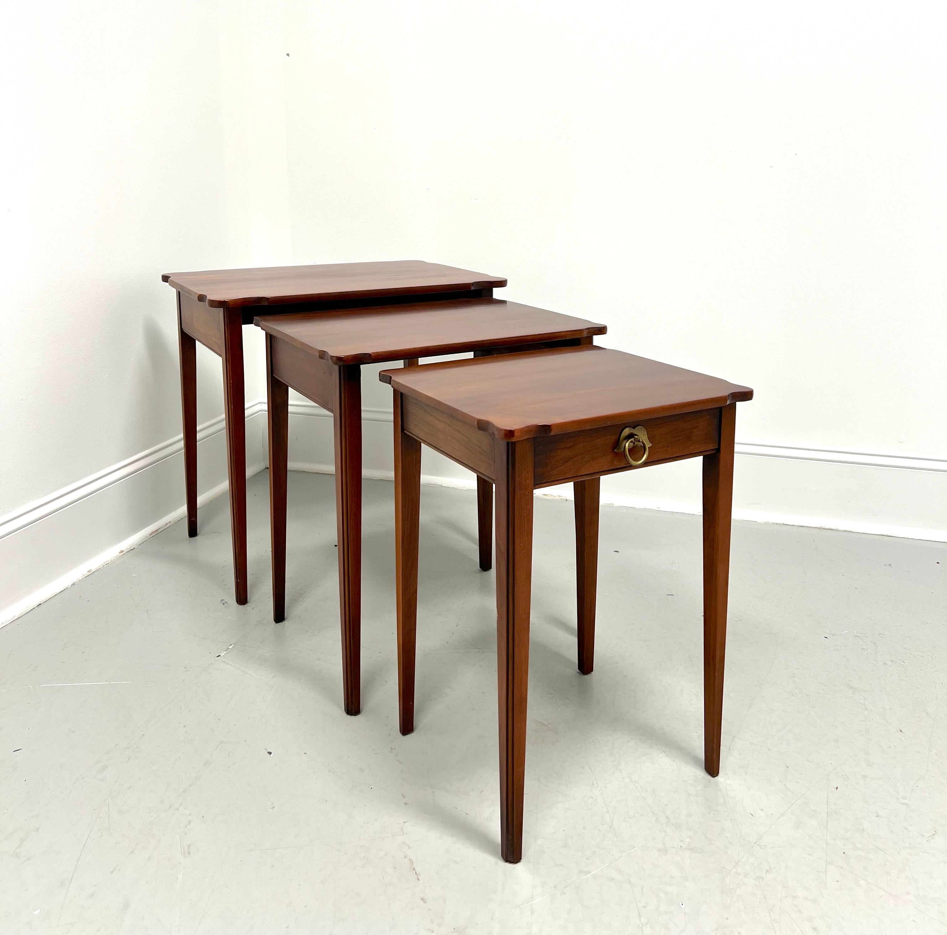 A set of three Chippendale style nesting tables by Statton Furniture. Solid cherry wood with their Centennial finish, serpentine shaped top with rounded corners & smooth edge, brass hardware, solid apron, and tapered straight legs with a fluted