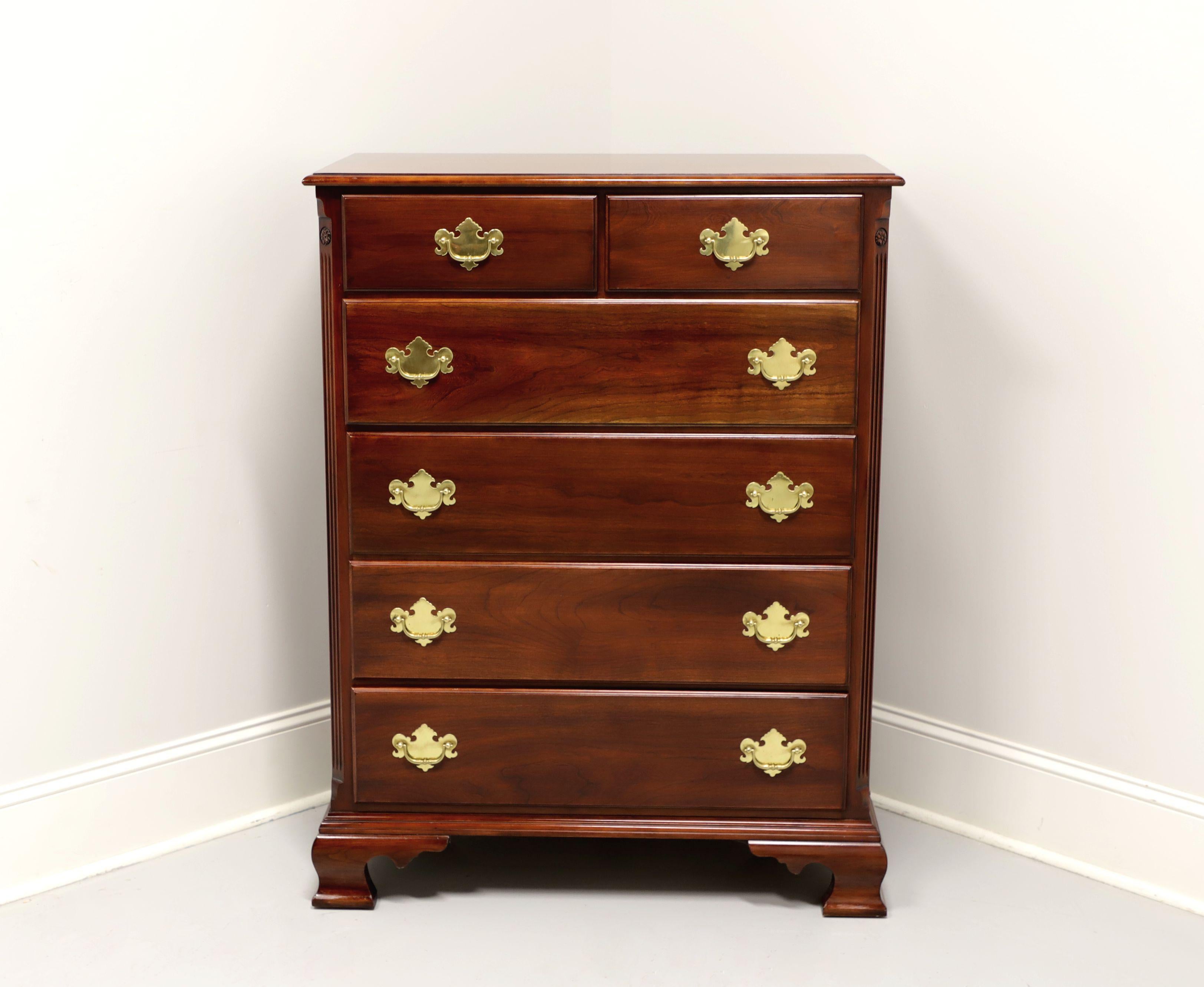 A Chippendale style chest of drawers by Statton Furniture. Solid cherry with their Centennial finish, brass hardware, carved side columns and ogee bracket feet. Features two smaller over four larger drawers of dovetail construction. Made in
