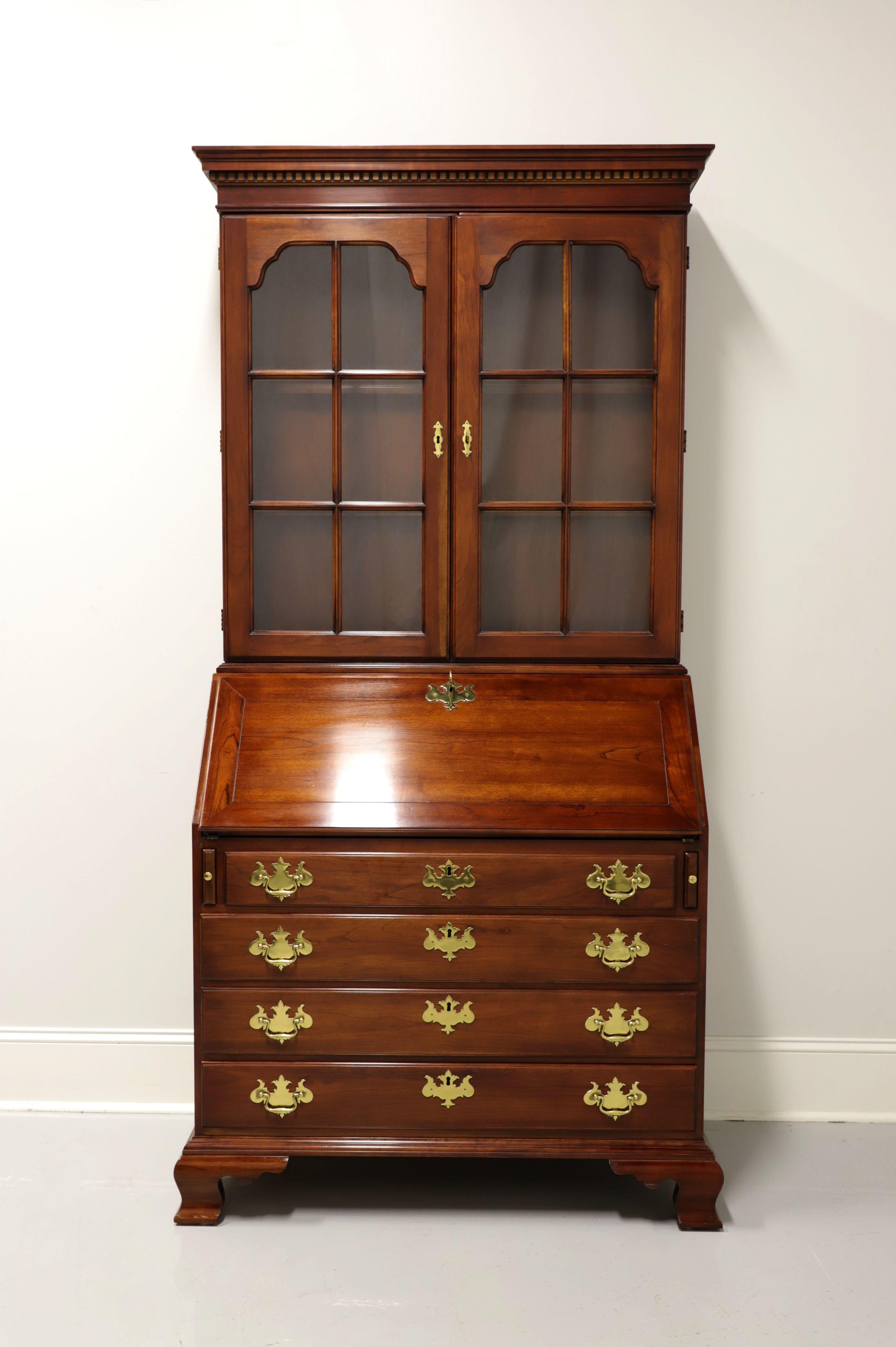 A Charlestown secretary desk in the Chippendale style by Statton, from their Centennial Collection. Solid cherry with brass hardware, crown & dentil moulding to top and ogee bracket feet. Features upper lighted cabinet with two six-pane glass doors