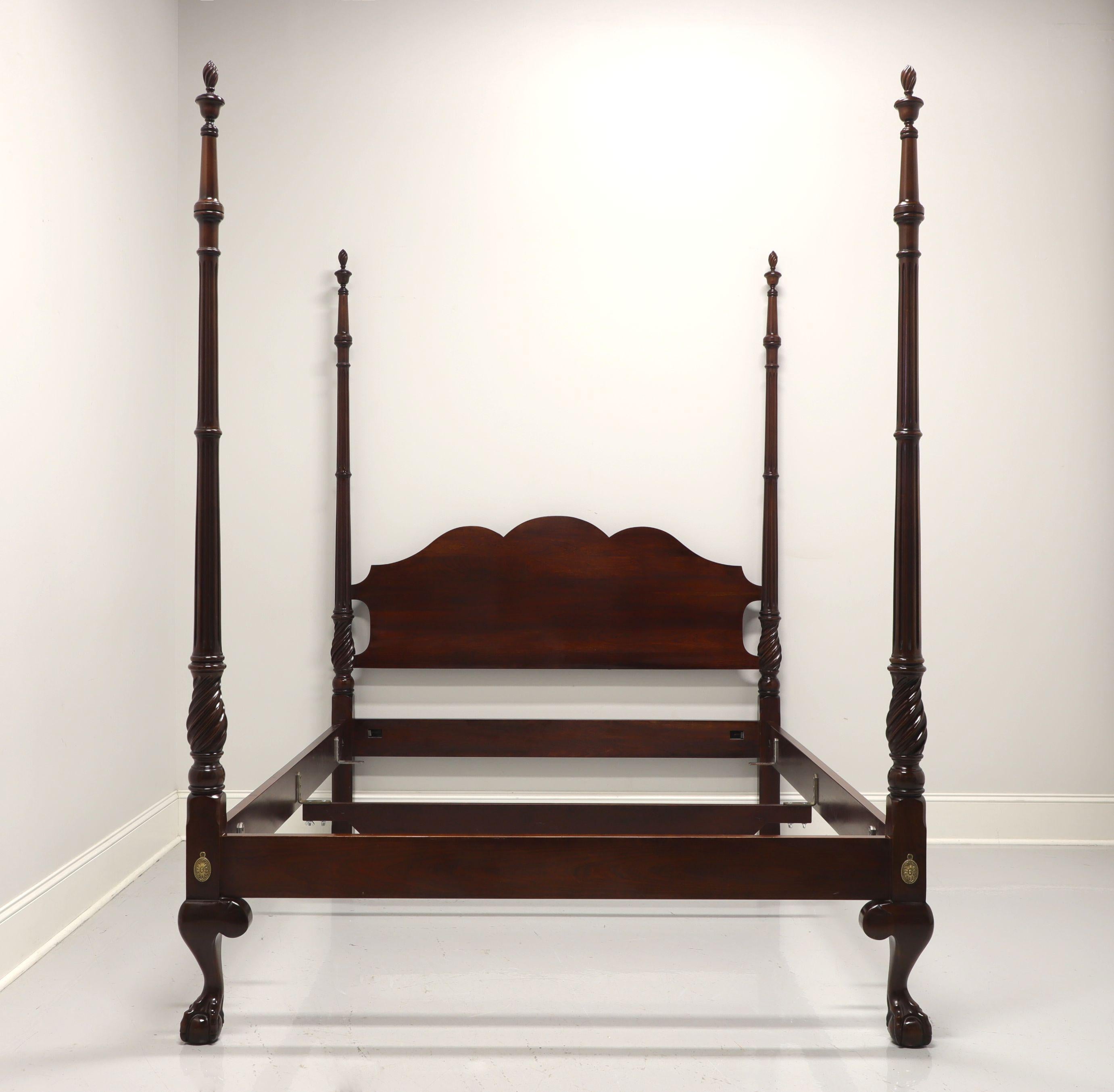 A Chippendale style queen size four post bed by Statton Furniture. Solid cherry with their Old Towne finish, four turned & fluted column like posts with finials and footboard with ball in claw feet. Brass covers to headboard and footboard. Metal