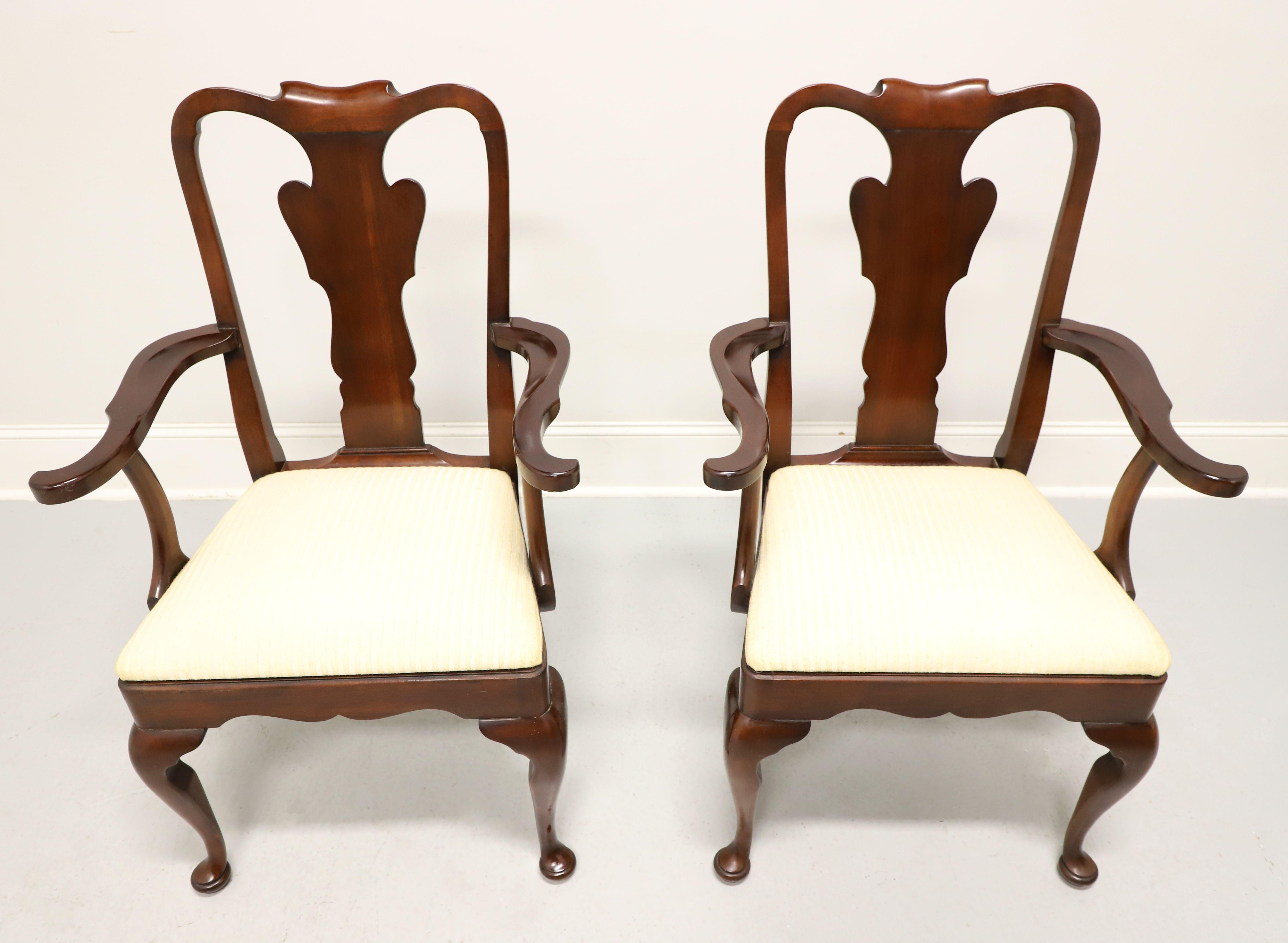 A pair of Queen Anne style dining armchairs by Statton Furniture. Solid cherry wood with their Old Towne finish, rounded crest rail, curved carved arms & curved supports, carved backrest & apron, neutral cream color textured fabric upholstered seat,