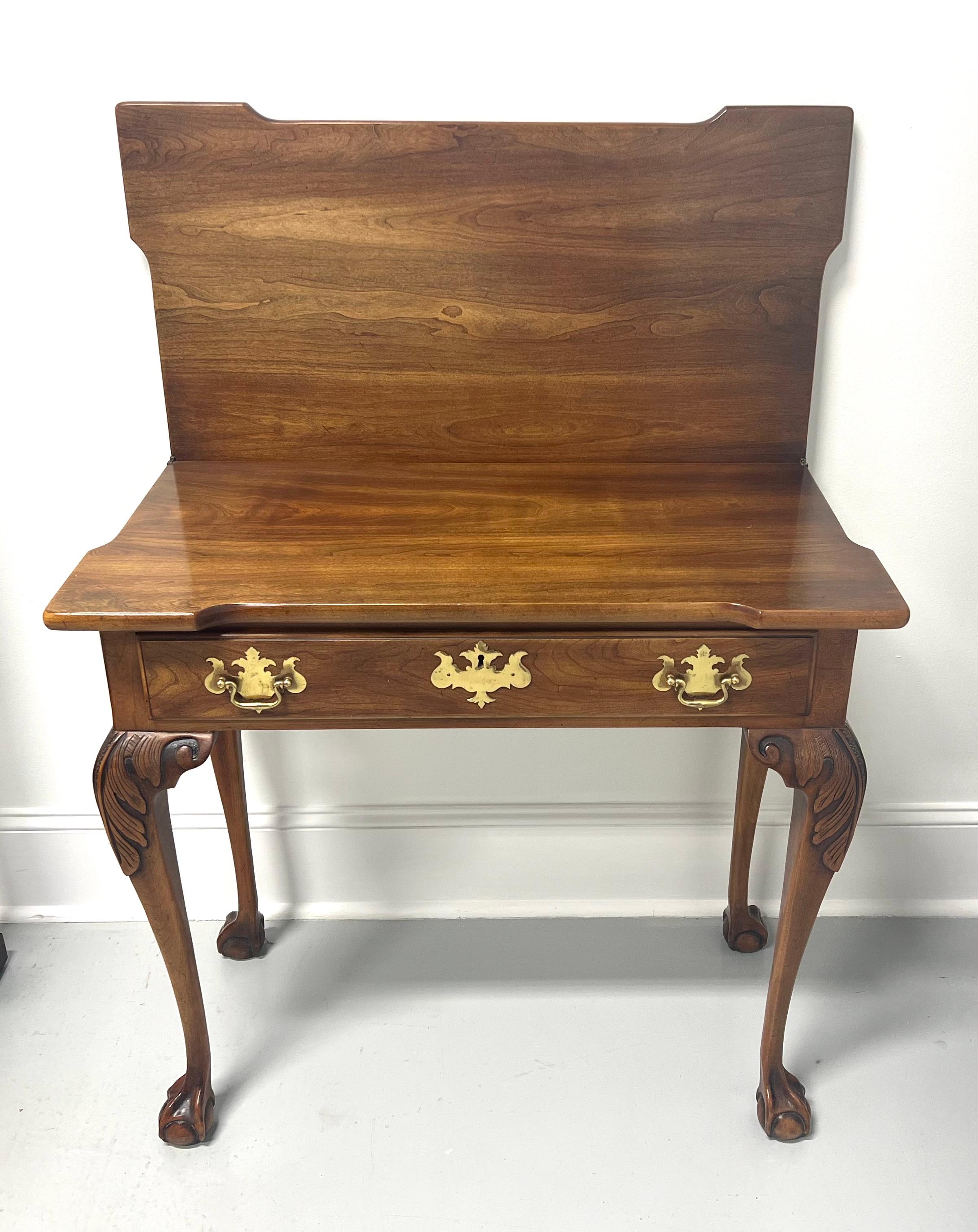 A Chippendale style gateleg game /console table by Statton Furniture, from their Private Collection. Solid cherry wood with their Oxford finish, flip up top with squared corners, one pull out back gateleg, acanthus leaf carved knees, cabriole legs