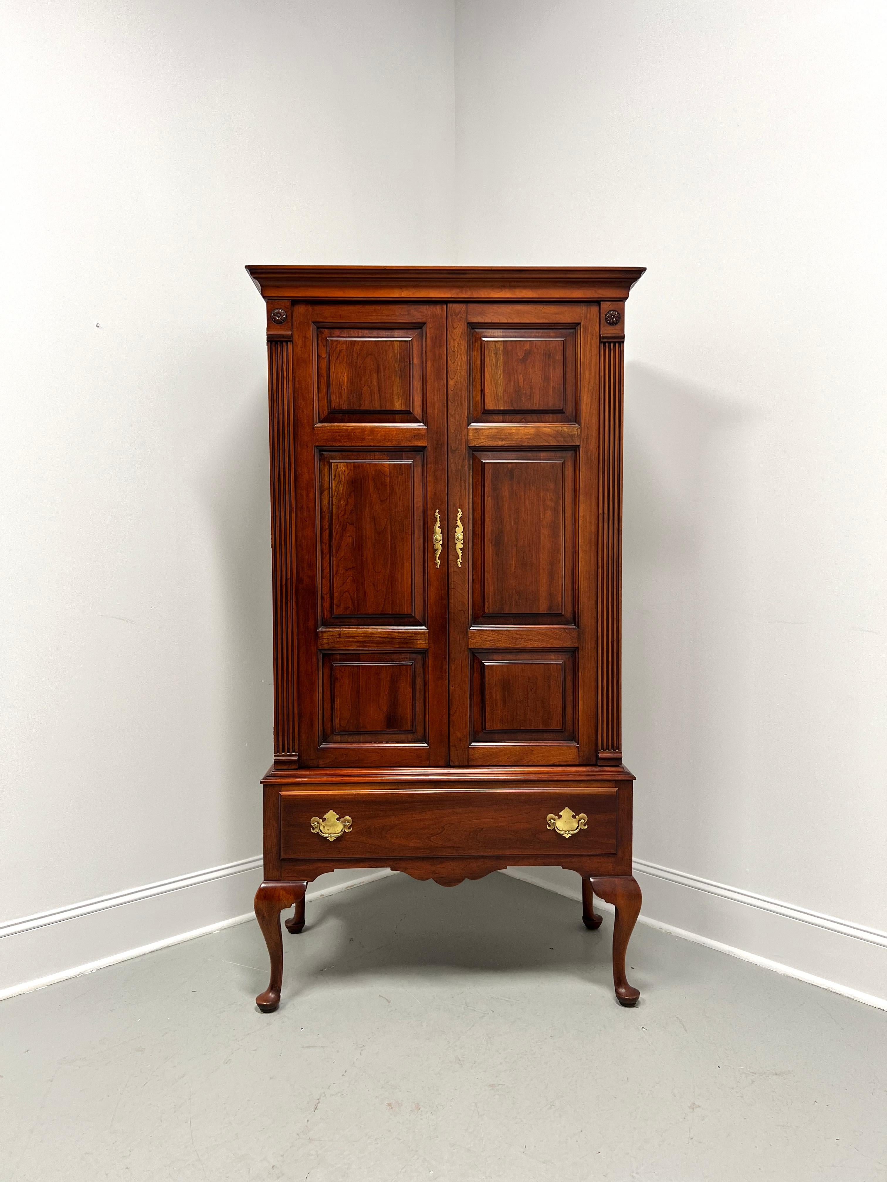 A Chippendale style gentleman's chest by Statton Furniture, from their Trutype Americana line. Solid cherry wood with their Centennial finish, brass hardware, crown molding at the top, fluted column-like front side corners, panel doors, carved