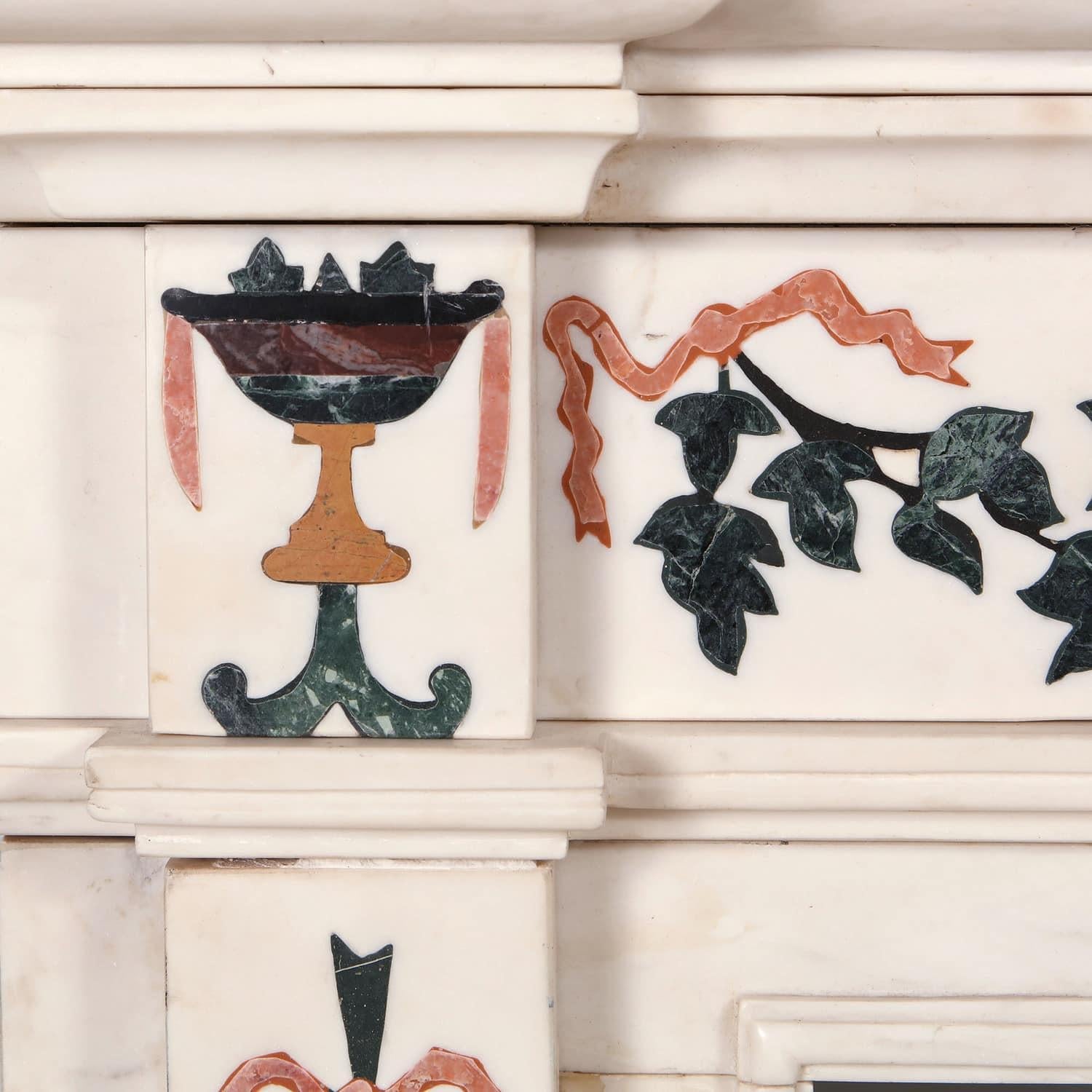 A white statuary marble neoclassical fire surround inlaid with classical vases, vine leaves and fruit with colored marbles.
England, 20th century
Measures: Height 130cm 51in
Width 162cm 64in
Depth 30cm 12in
Aperture 102 x 103cm - 40 x 40.5in.