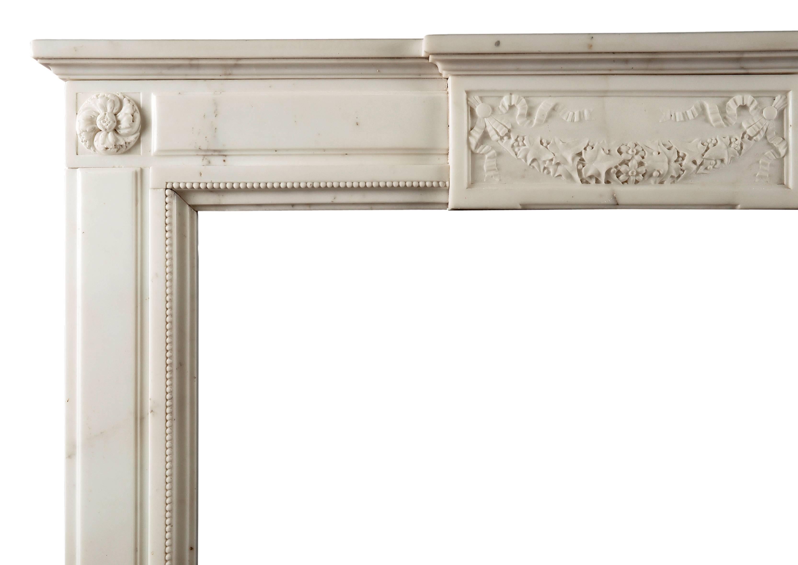 A good quality statuary marble antique fireplace in the Louis XVI manner. The panelled jambs surmounted by carved rosette paterae, the frieze with swags, drapery and foliage to centre block, French, 19th century. (Photo’d prior to full