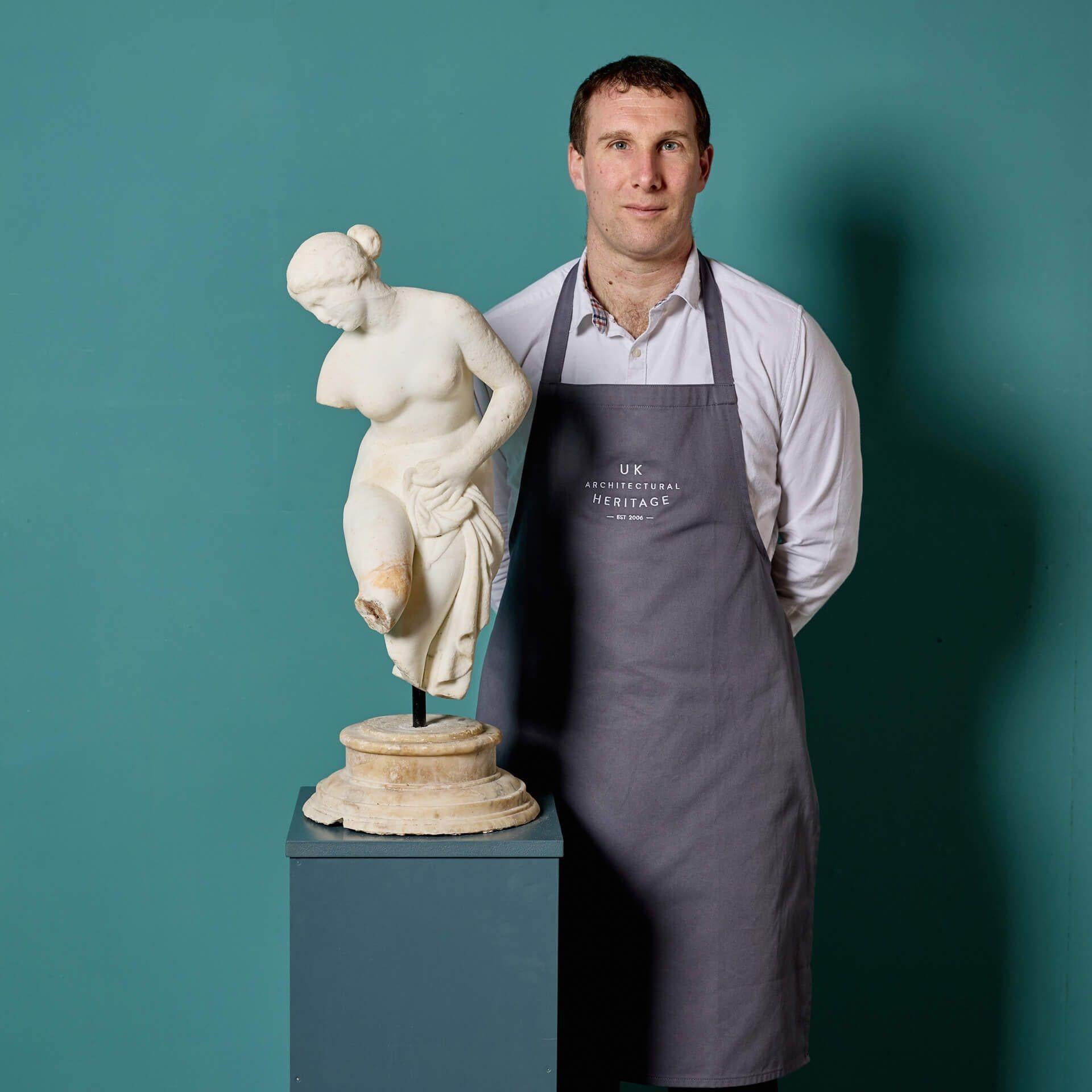 A white statuary marble sculpture of the bathing Venus after the antique, sourced from the estate of the late David Cornwell, best known at the author John le Carré.

Dating to circa 1840, this Italian sculpture of Venus is mounted onto a custom
