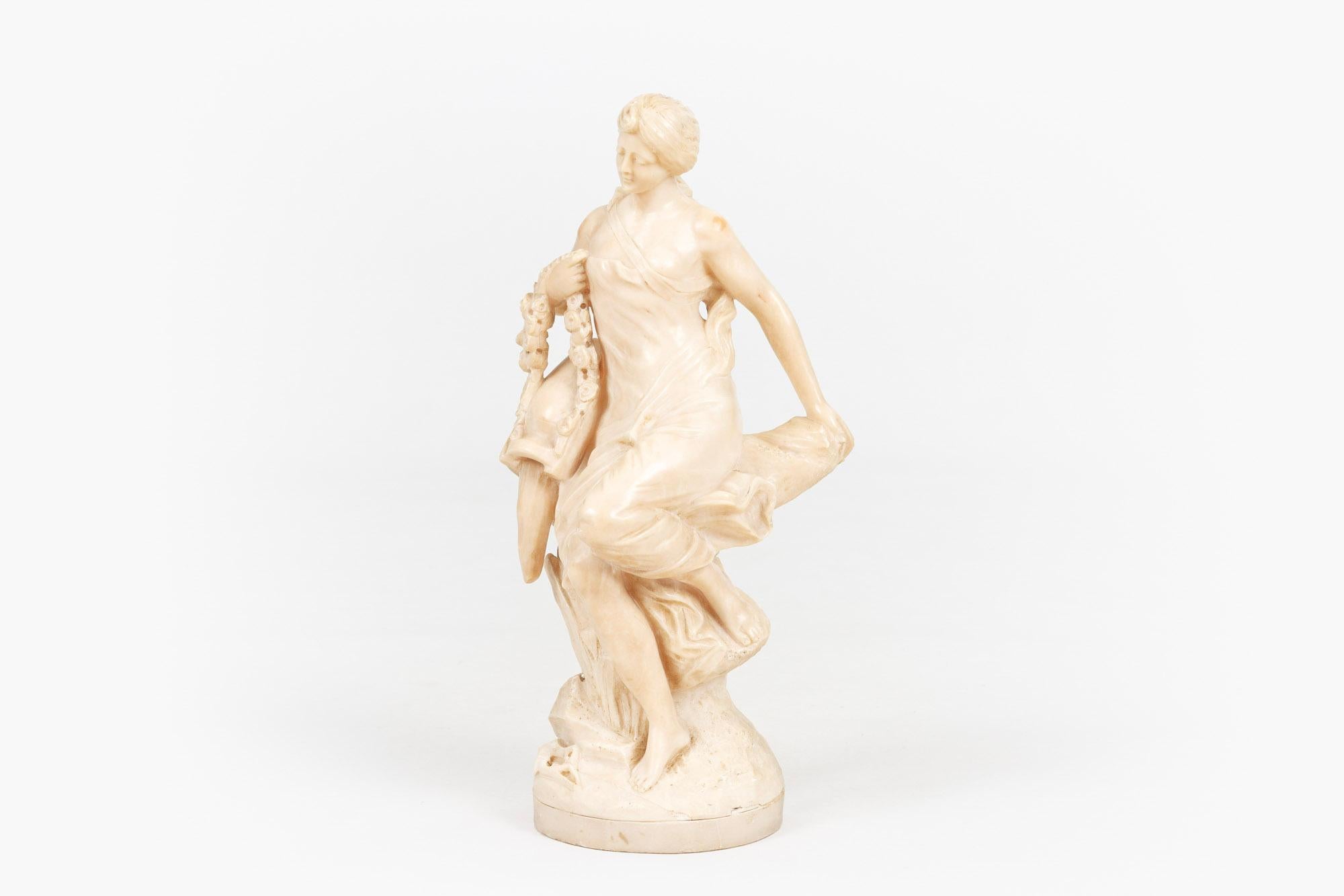 19th century neoclassical statuary figure sculpture by Edward Drouot depicting female figure seated
on a rock with urn flowing water and garland of foliate motif.