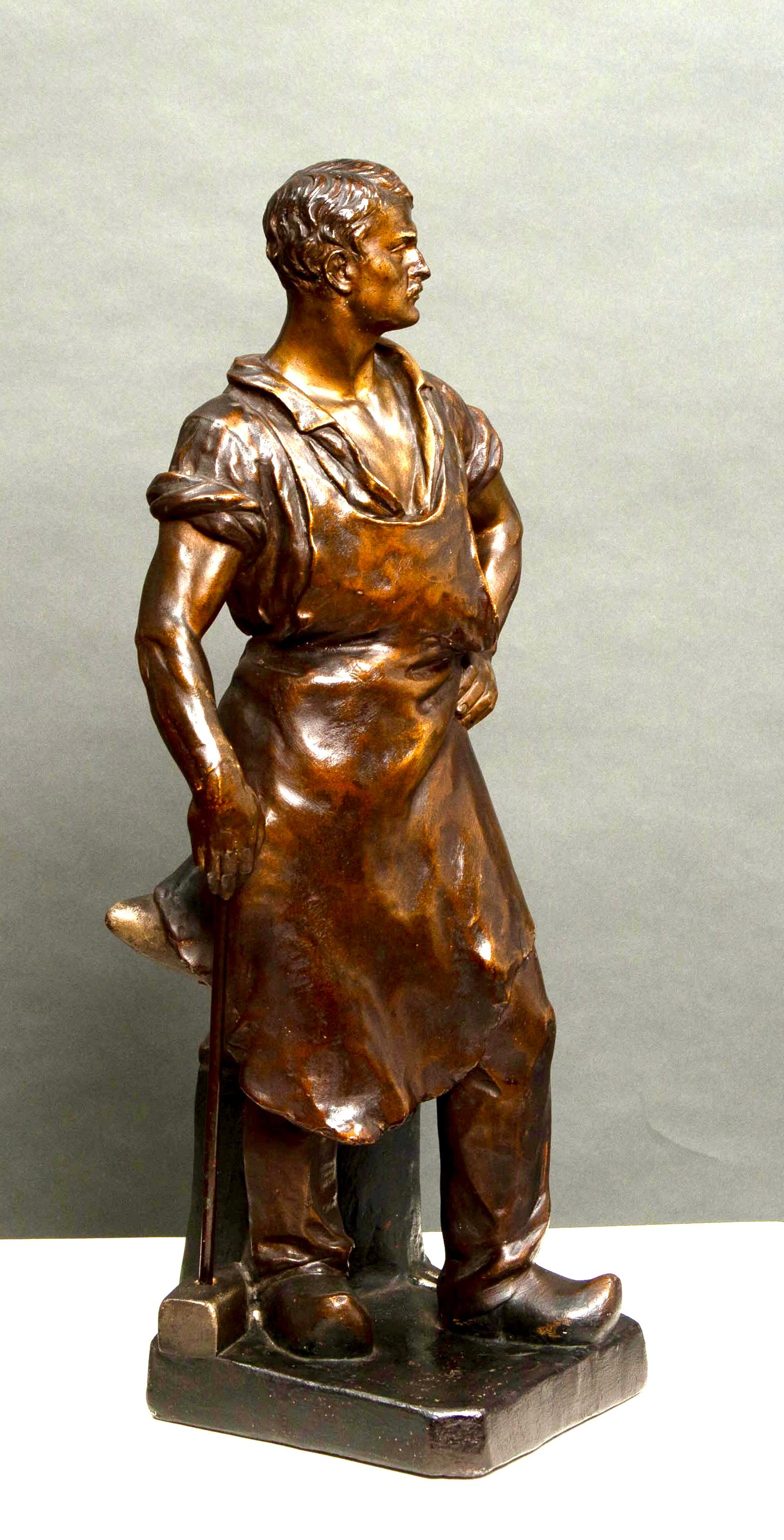 Terracotta Statue of a blacksmith with bronze patina For Sale