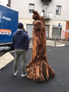 Statue of a Tibetan Monk or Buddha Disciple in Japanese Olive Tree