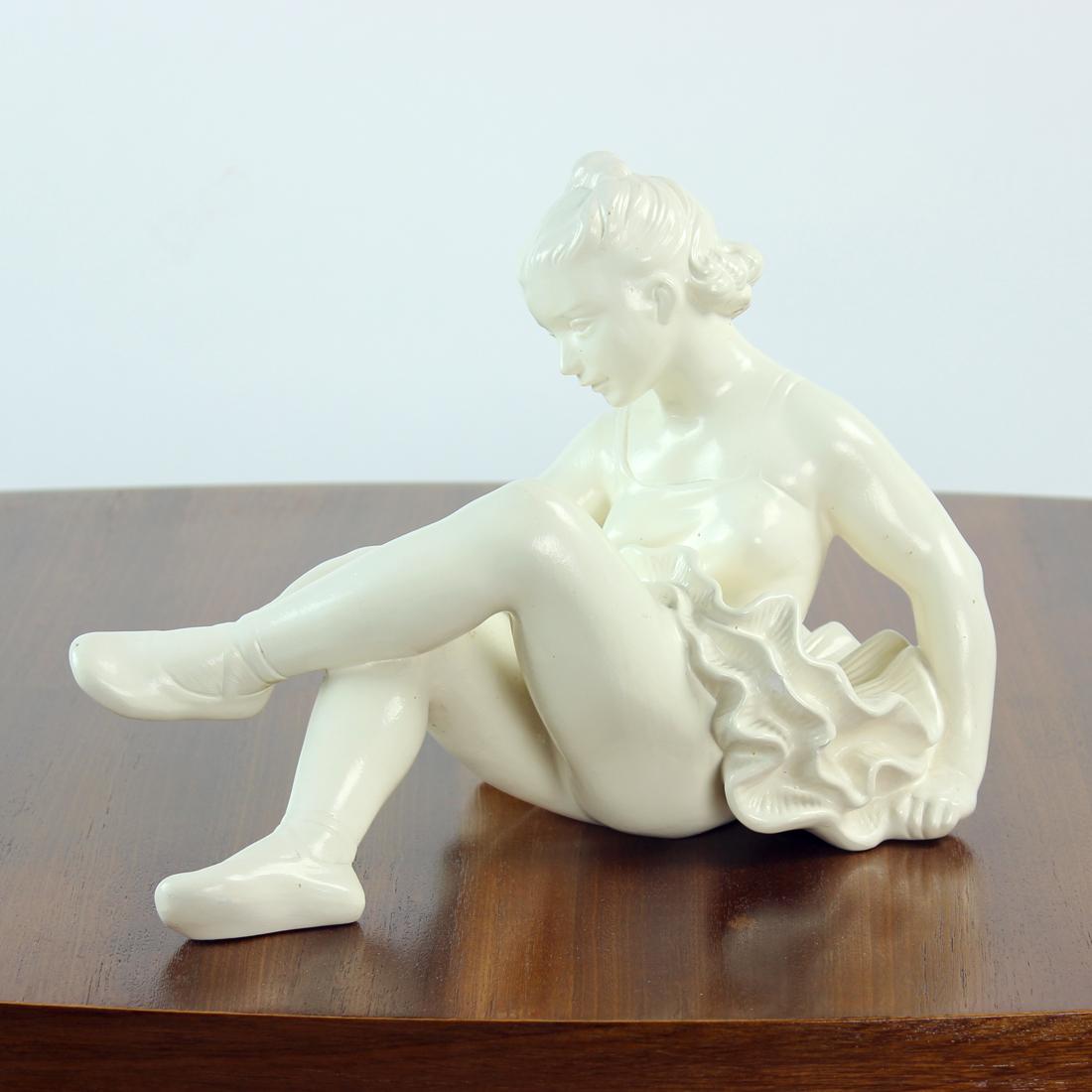 Beautiful vintage statue of a sitting ballet dancer. Produced in 1966 by Jihokera company in Czechoslovakia. The statue is made of glazed plaster. The color is cream white. The statue shows beautiful details in the dress and expression of the young