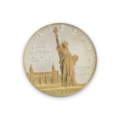 Pièce d'un dollar en argent avec des reflets dorés « Statue de la Liberté – Ellis Island 1986 », pièce de monnaie