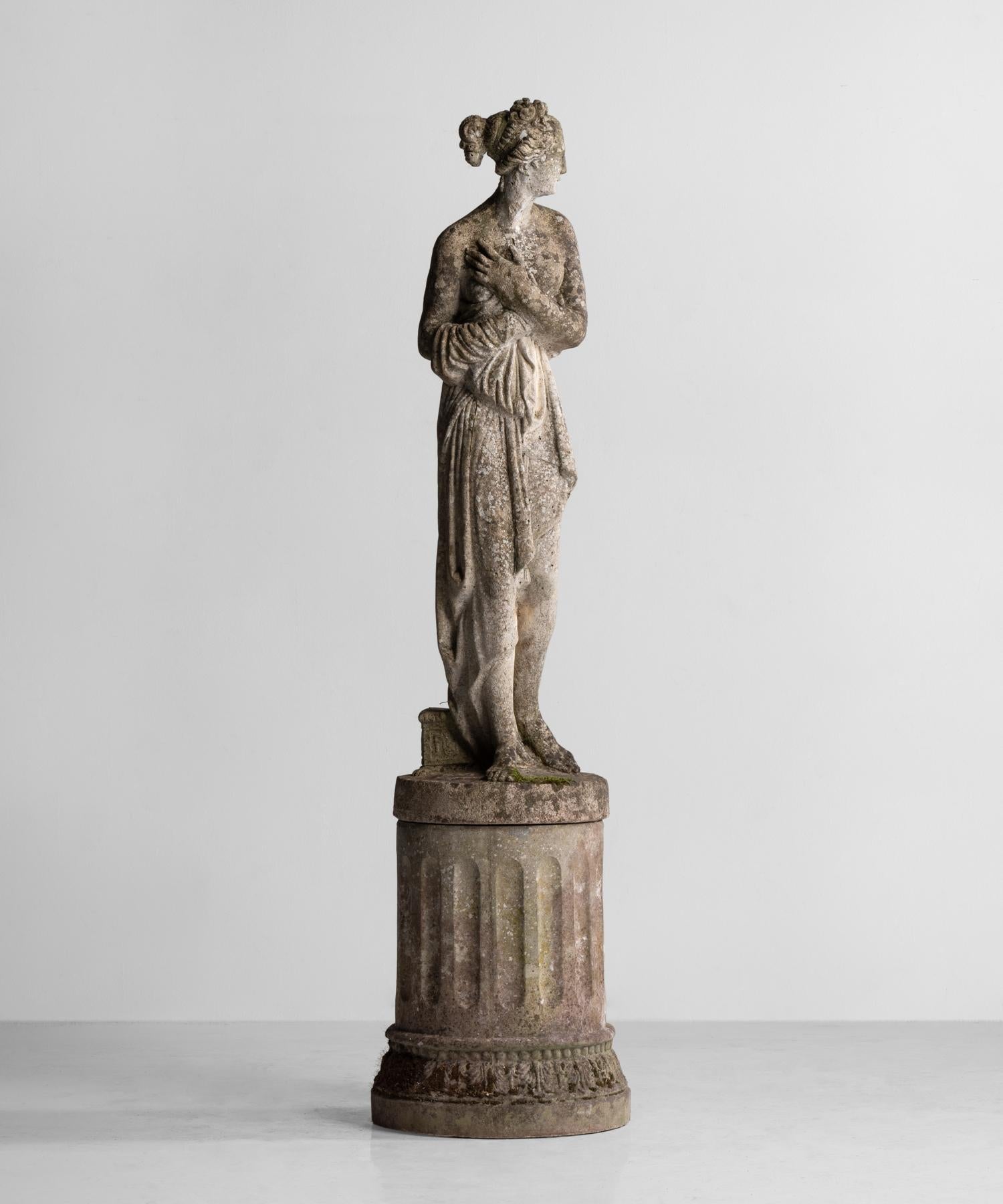 An elegant composite stone representation of Venus with a wonderful patina and original column pedestal.