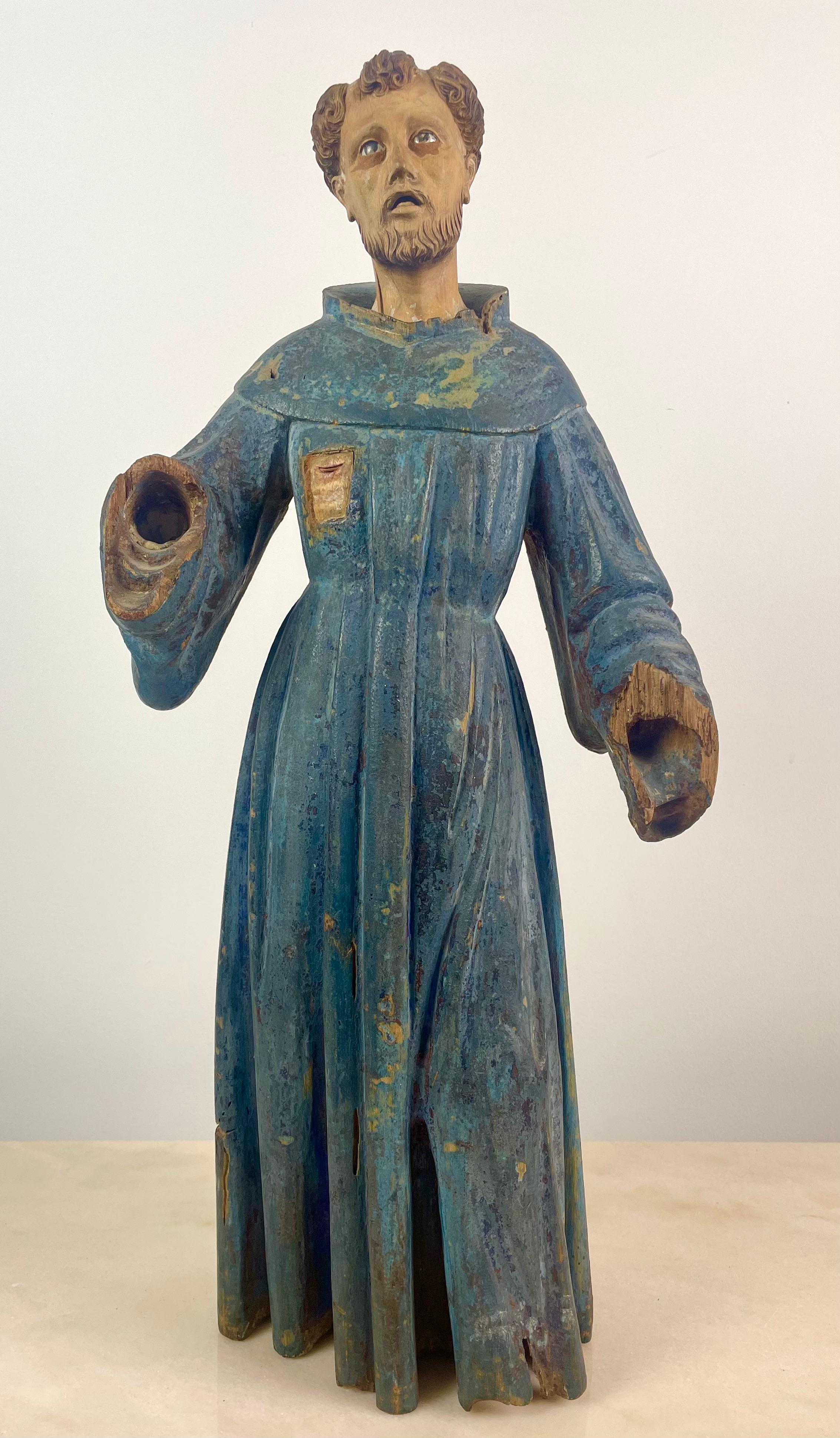Very beautiful Religious Statue in Polychrome Carved Wood 17th-18th Century Of Saint Francis of Assisi.
His Eyes are made of glass.
He is represented standing, his face and eyes turned towards the sky. He is dressed in a blue sackcloth robe,