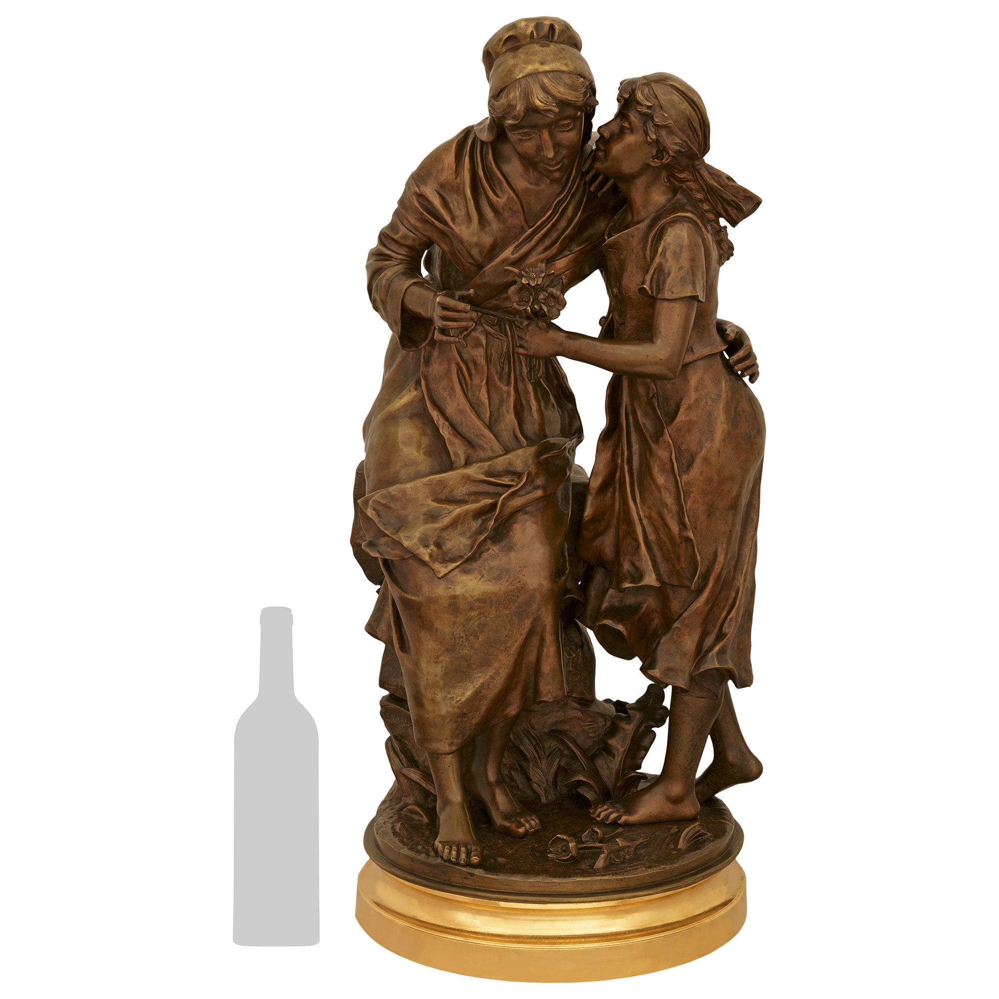  very charming and high quality French late 19th century patinated Bronze and Ormolu statue titled Fête de la Petite Mère, signed by Émile Nestor Joseph Carlier. This wonderfully detailed statue is raised by a handsome mottled circular Ormolu base.