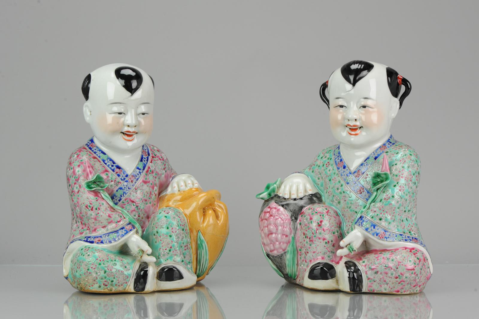A very nicely decorated pair of statues

He-he Heavenly twins

The Heavenly twins are shown as two boys carrying a box and a lotus which symbolizes a wish for peace: 'hé' ? (box) and harmony ? hé (lotus). One may also be holding a bowl over