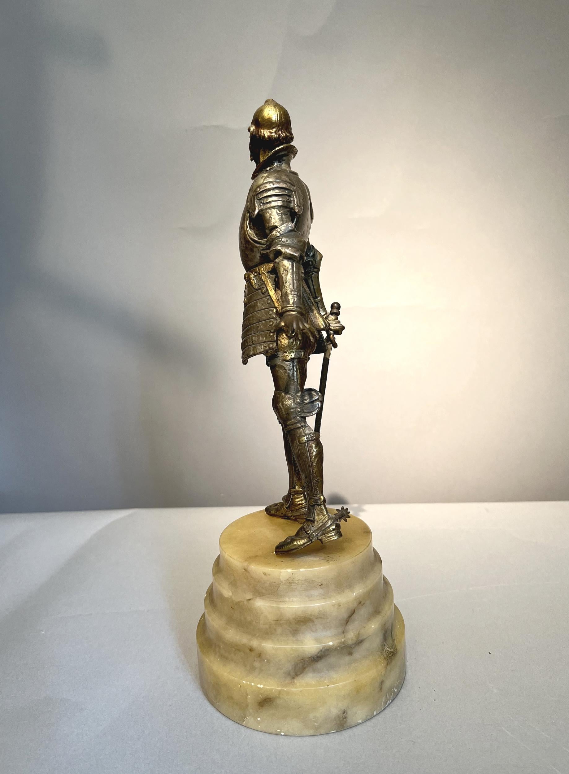 Statuette de Don Quichotte en bronze doré et argenté, sur une haute base en albâtre.
