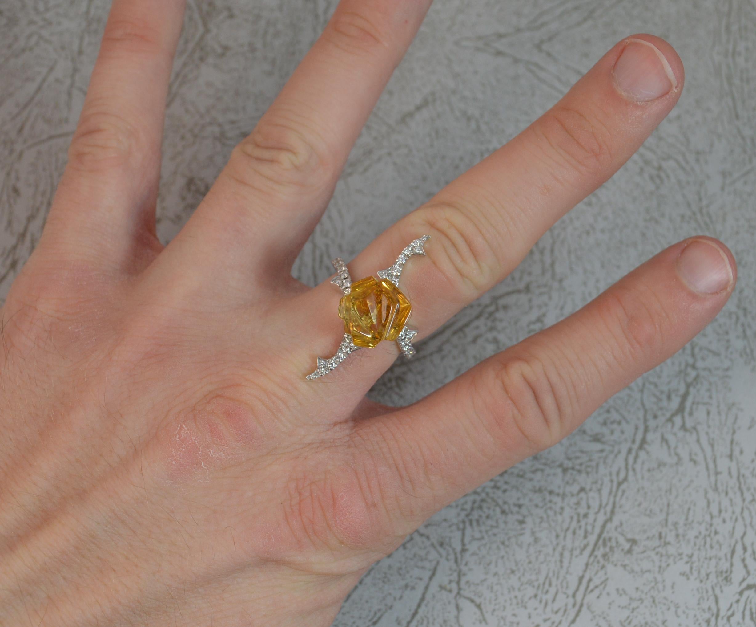 A stunning Staurino designer ring.
18 carat white gold example.
Designed with a carved yellow topaz of floral form to centre, 12mm diameter. Surrounding and multiple round brilliant cut diamonds, vs/e-f.
31mm total height.

CONDITION ; Excellent.