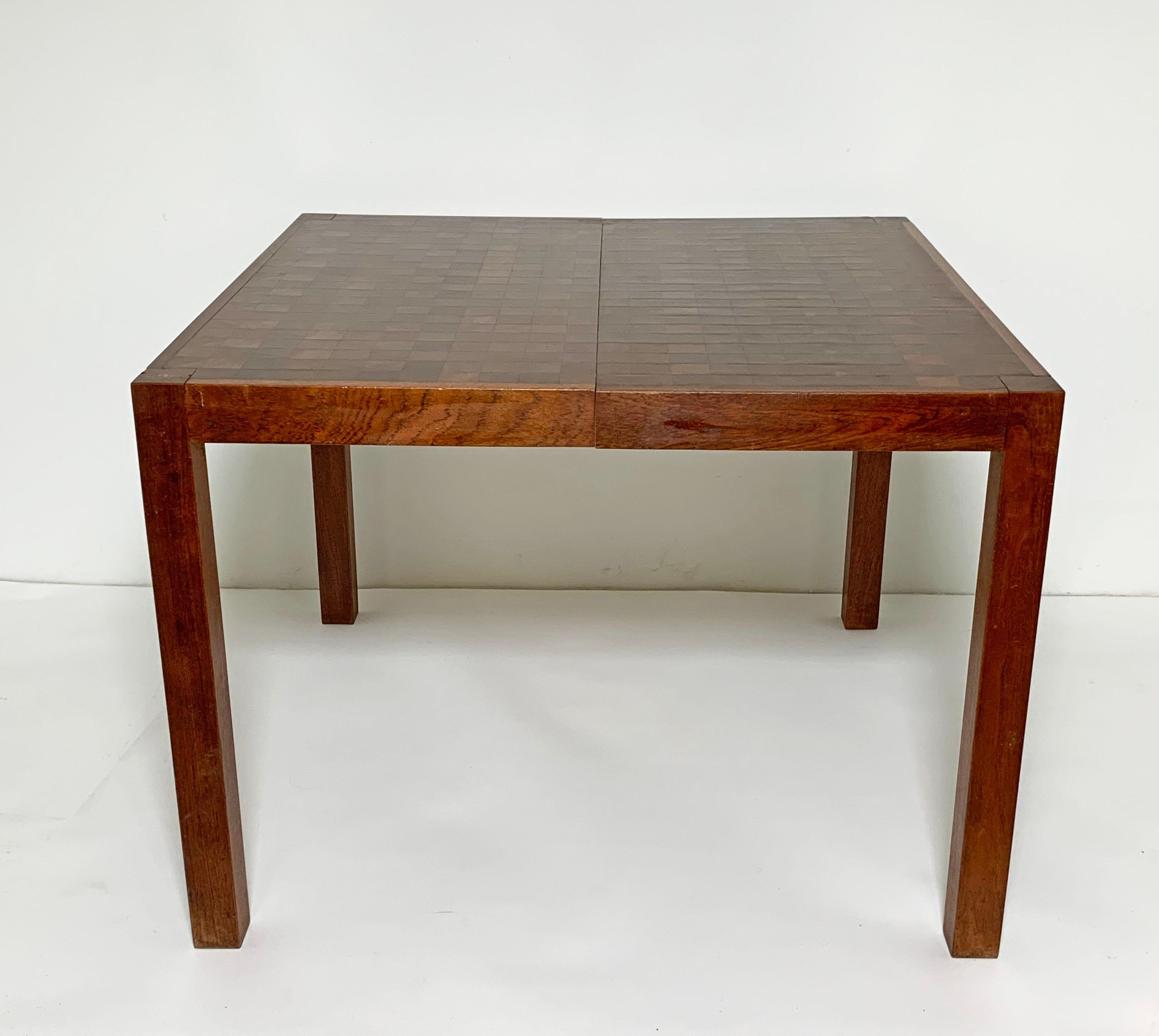 Danish Modern dining table with top and leaves of highly figured blocks of staved figured teak, most certainly Scandinavian but unmarked as to country of origin. Measures 40.5