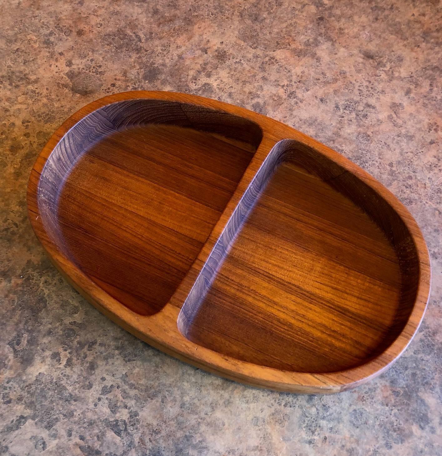 Excellent staved teak double bowl by Jens Quistgaard for Dansk, circa 1970s. The bowl is quite functional and in excellent condition.
