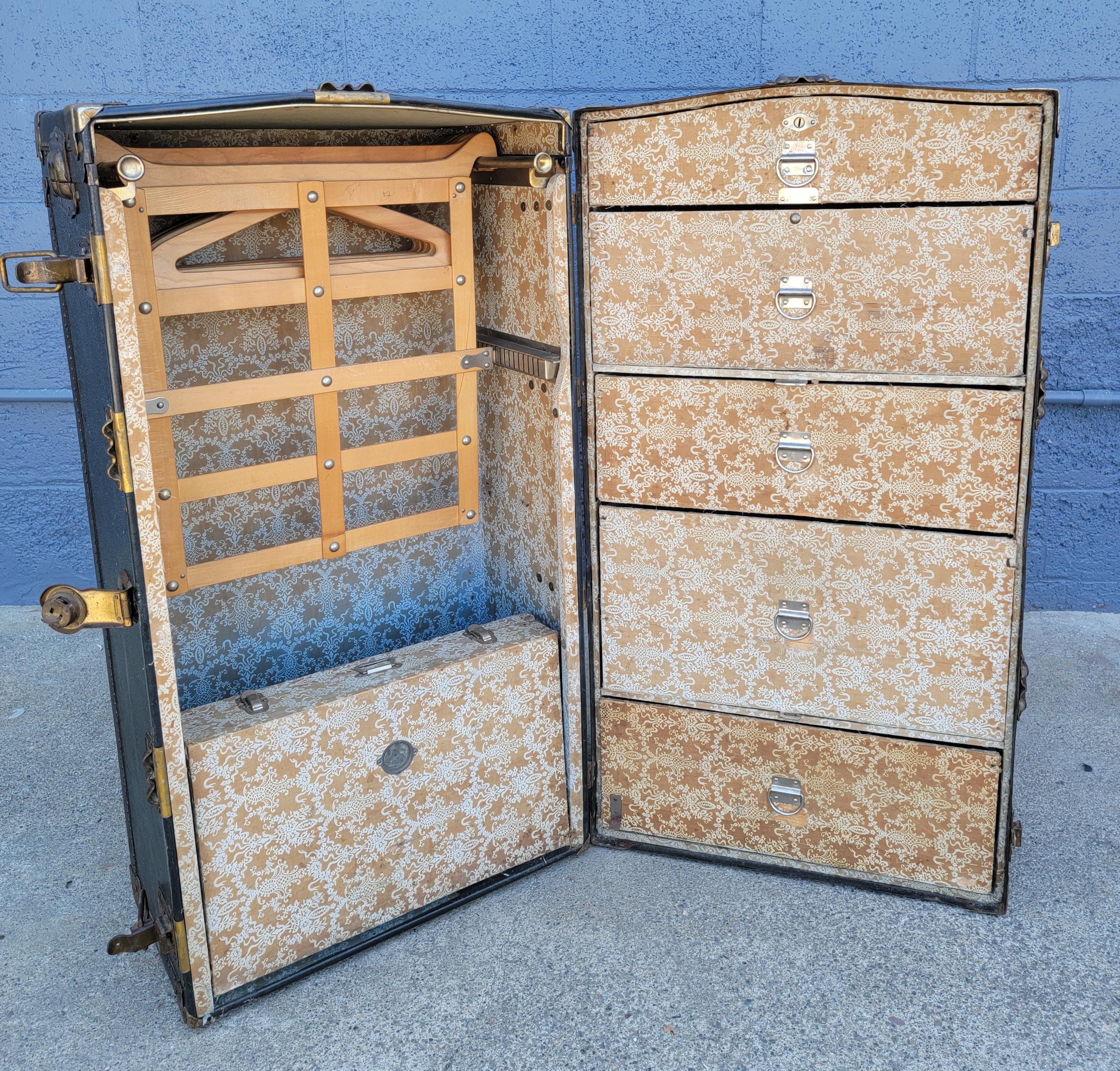 Early 20th century wardrobe trunk by Belber. Retains several original transport paper labels from San Francisco and Stockton California. Complete fitted interior intact. Original vintage, rustic condition. Lock has been pried open and is no longer