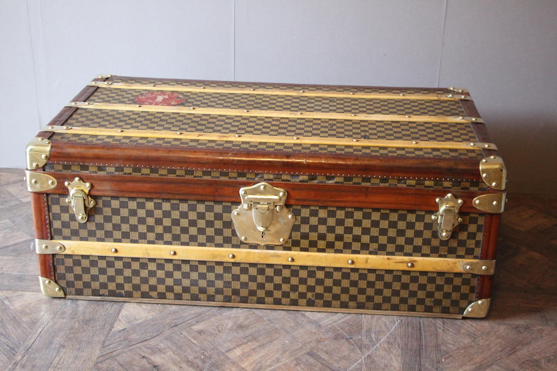 Very unusual and magnificent French steamer trunk in checkers canvas, it features leather trim, solid brass corners, clasps and side handles as well as 