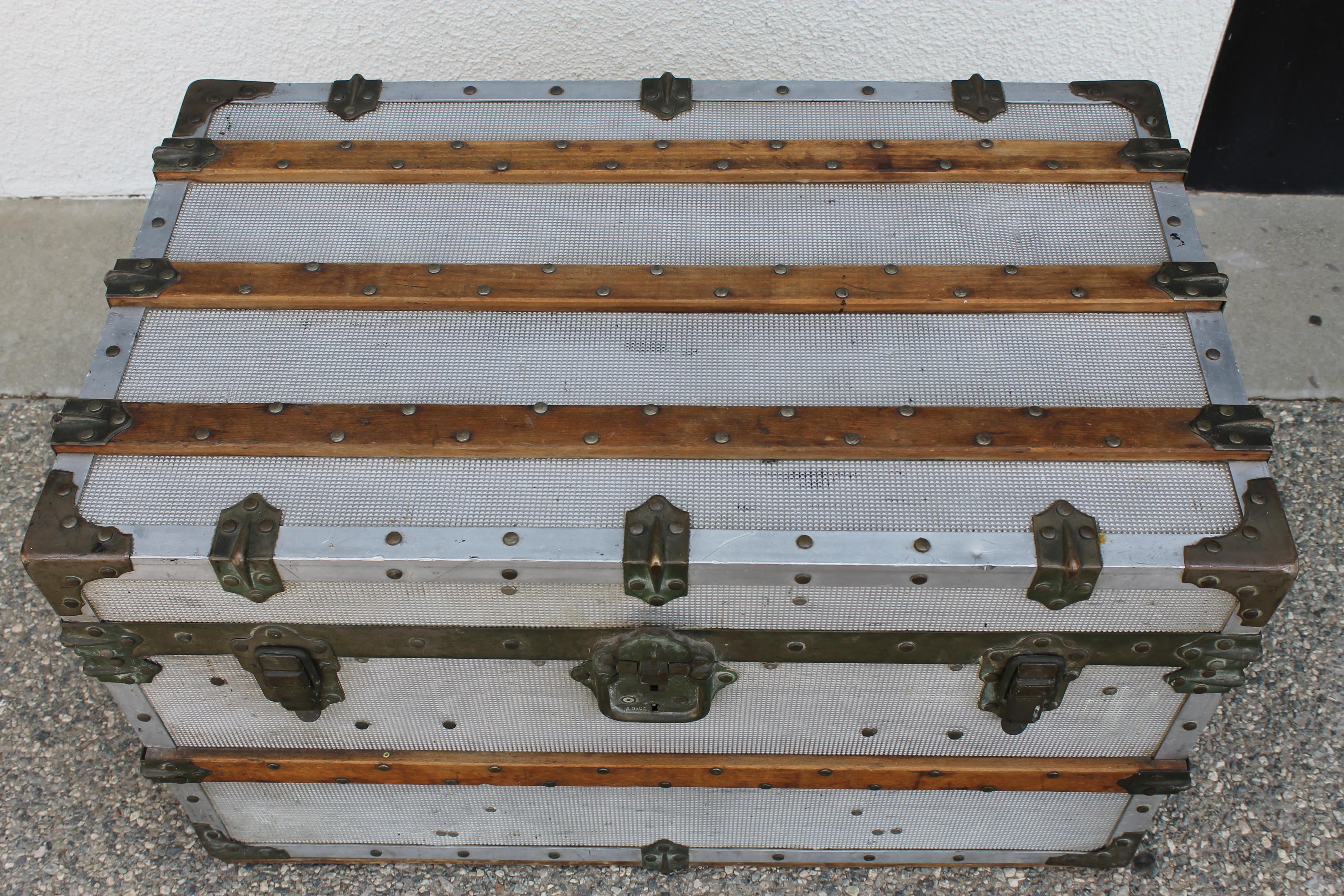 Aluminum steamer trunk made in Paris, France. Lock contains company name. Trunk measures 31