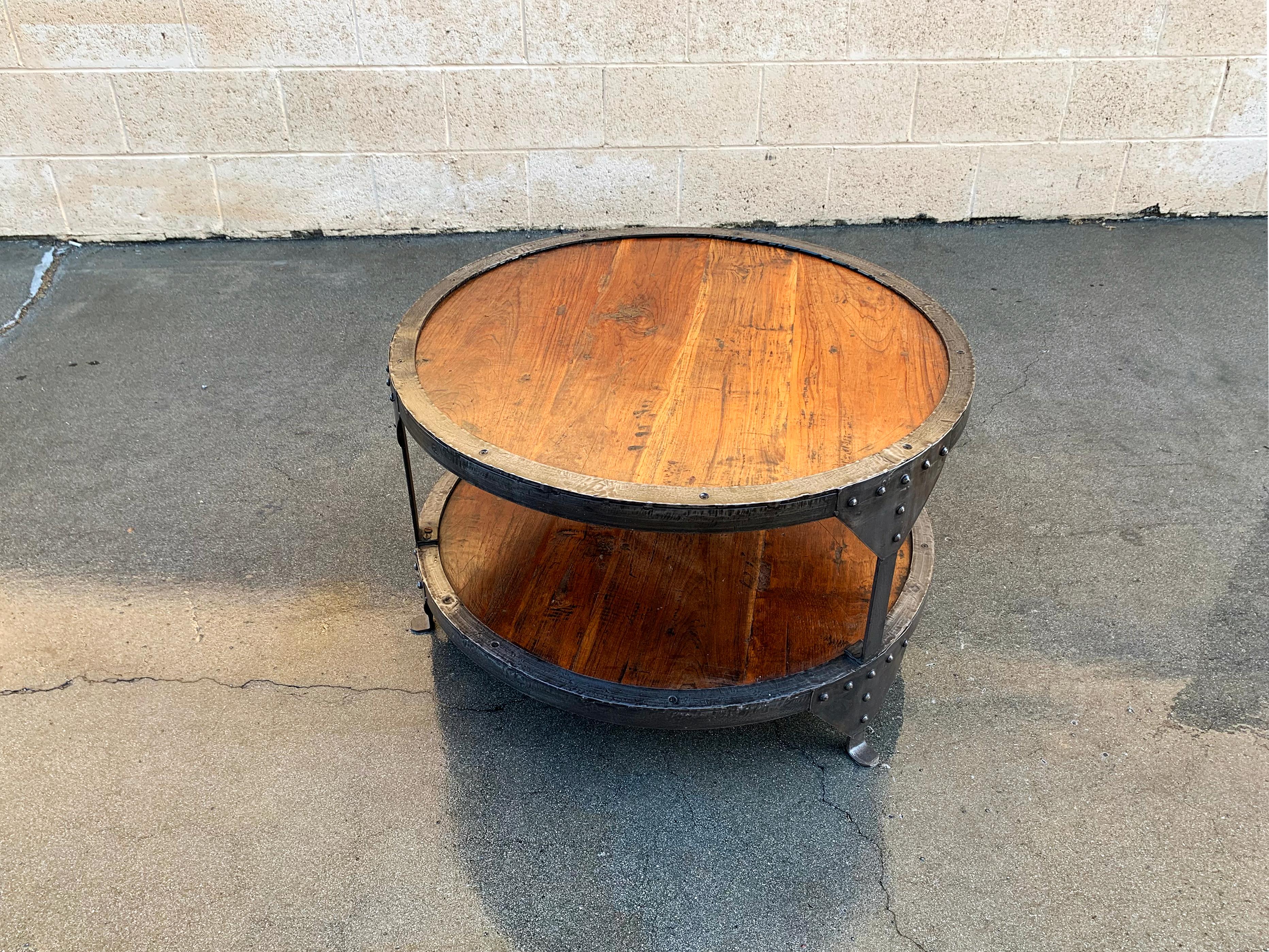 Vintage steel and wood round side table, with lower shelf, circa 2000. The combination patina steel and rustic wood comes together for a machine age/ Steampunk inspired design. One available. 

Dimensions: 30