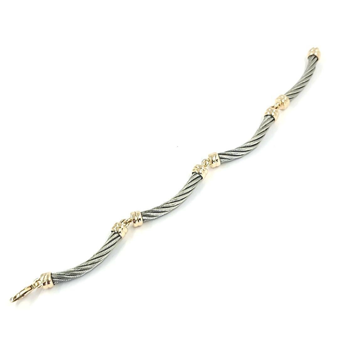 18 Karat Yellow Gold and Steel Cable Link Bracelet Weighing 19 Grams with Lobster Clasp. 7.5 Inches Long. Charriol style design.