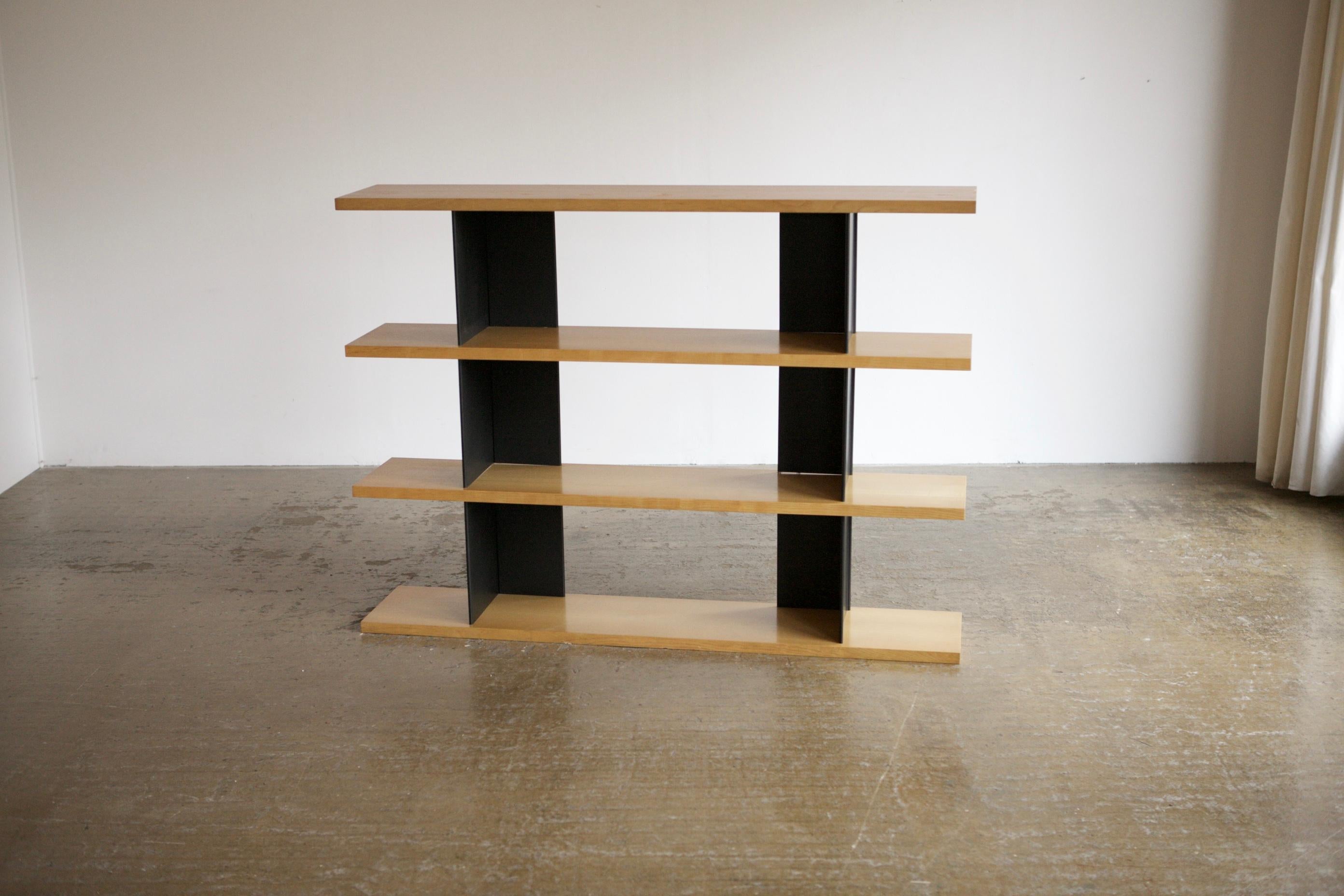 Modernist piece that takes design notes from Charotte Perriand. With four thick beech shelves and steel black sheet metal brackets. Free standing and can be packed down for shipping.
