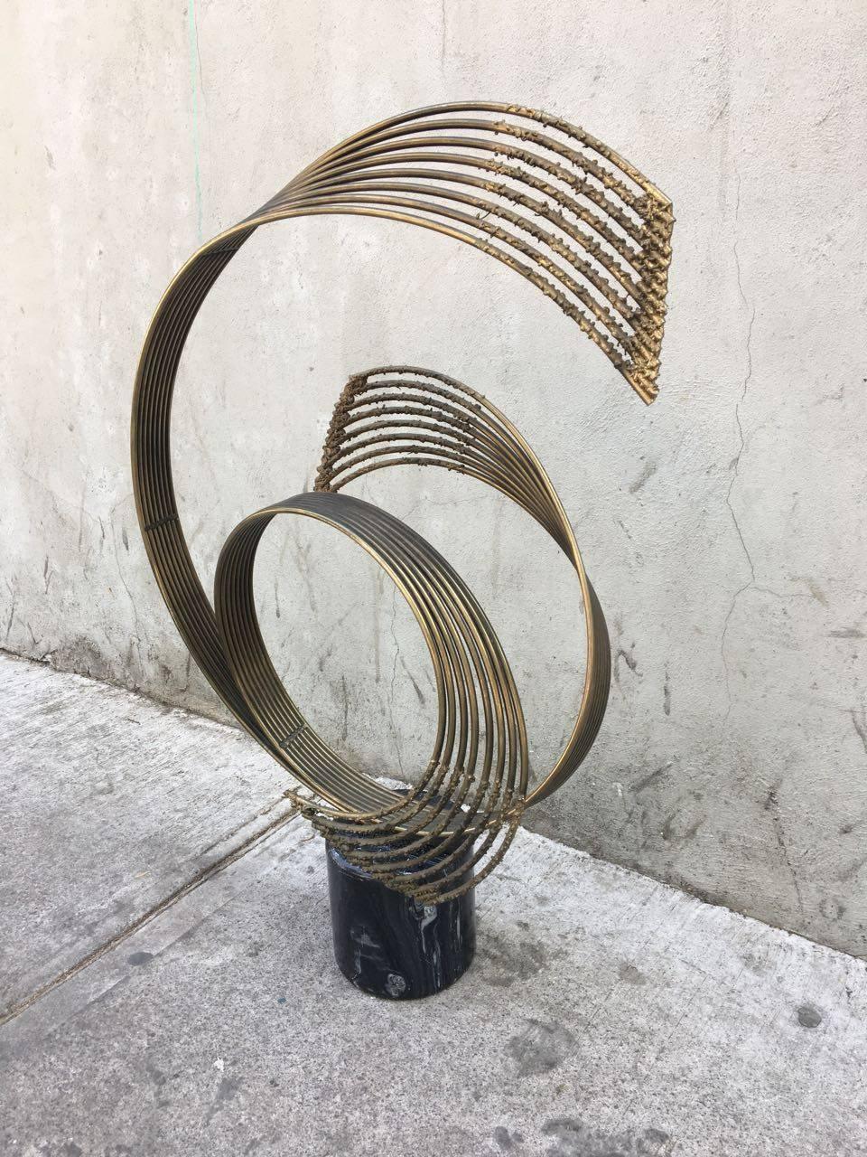 Abstract sculpture by Curtis Jere, made in steel and brass, with marble base.

Curtis Jere.