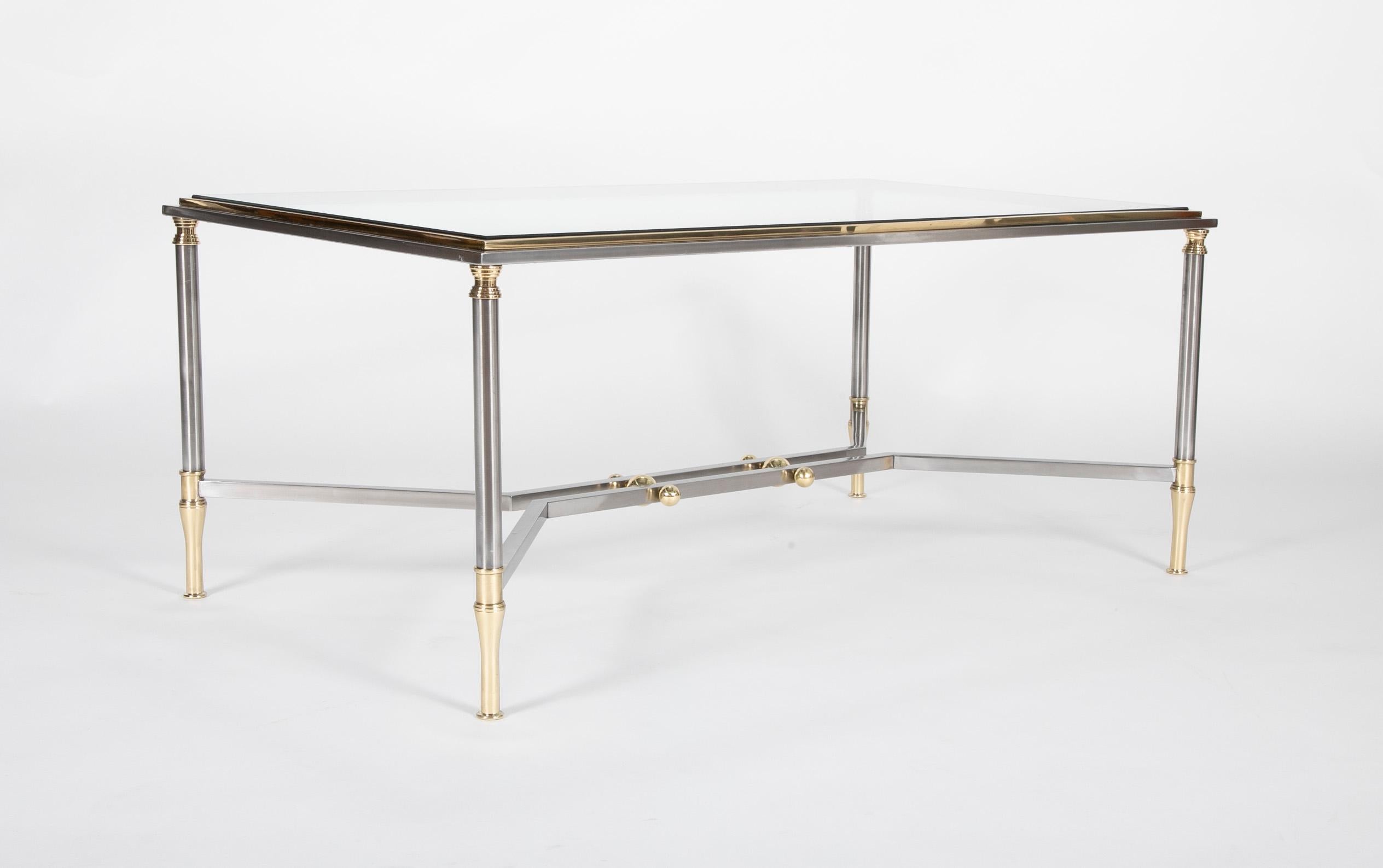 A Maison Jansen style coffee table in steel and brass with glass top.