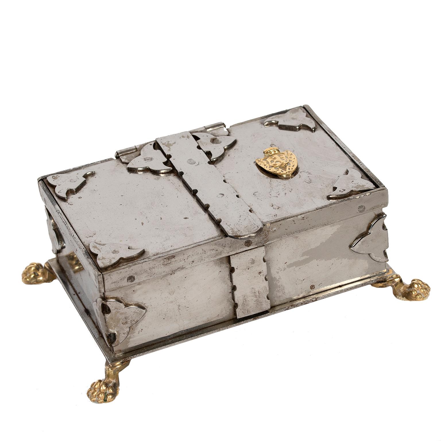 This exceptional and unique stainless steel box from Italy with
brass details including lion paw feet is lined in original brown fabric.