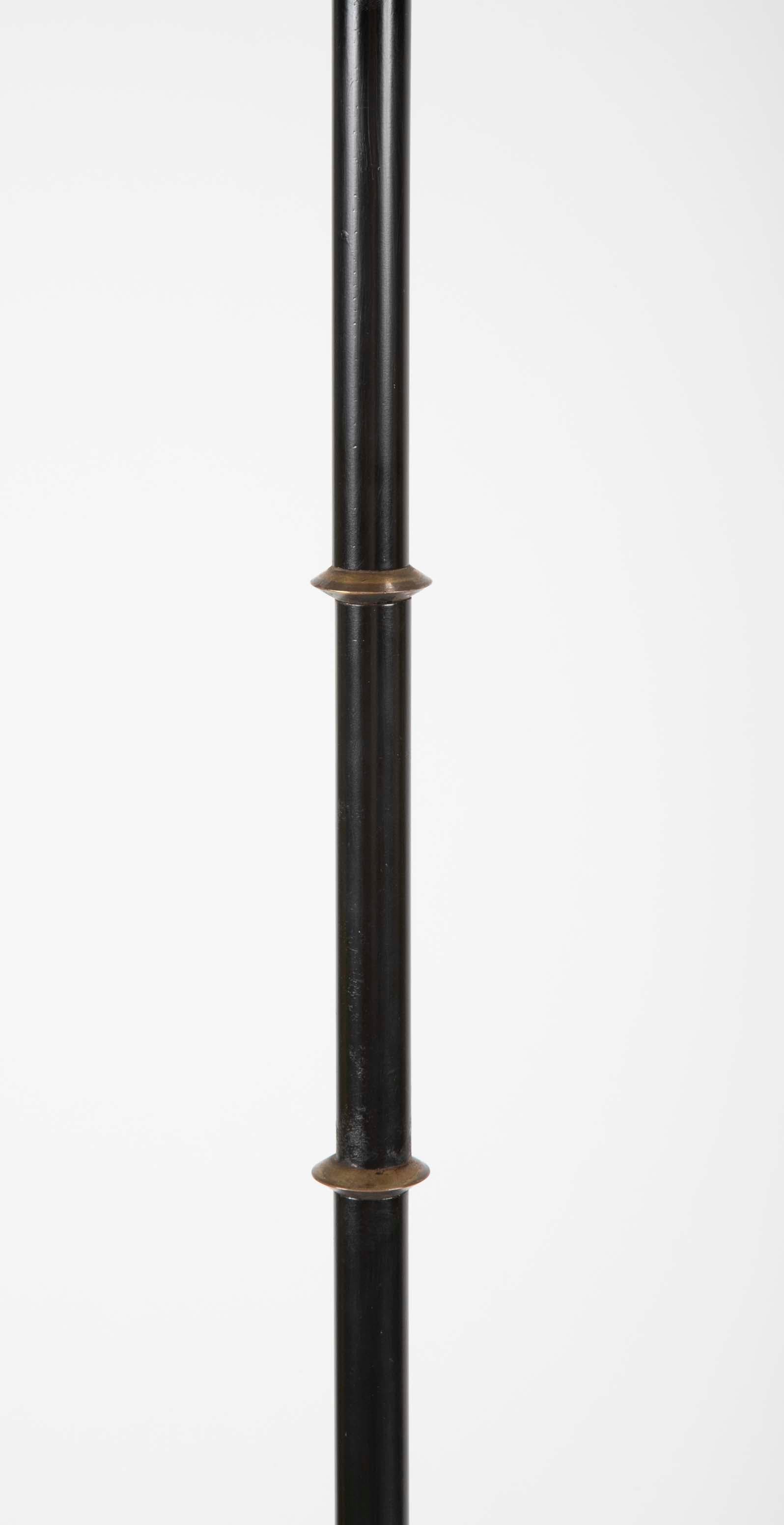 A sharp looking steel and brass floor lamp in the manner of Jacques Adnet. 
Measures: Shade- 16