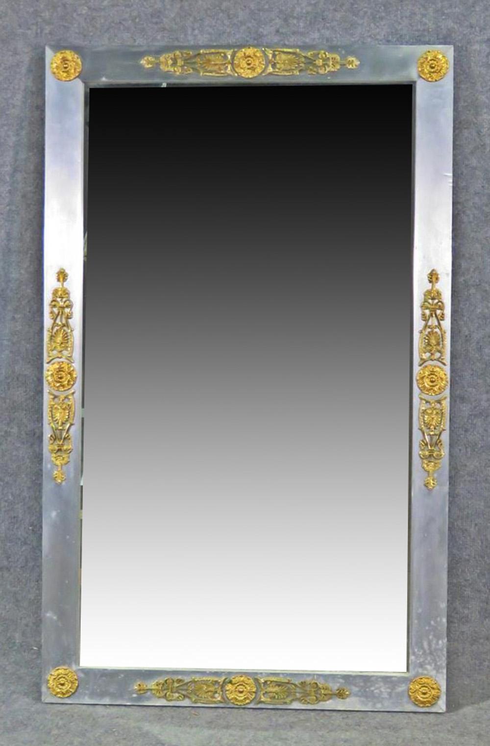 This is a gorgeous John Vesey attributed mirror. The glass is in good condition with minor signs of age. The frame has minor scuffs or scratches. Metal with brass accents. 42