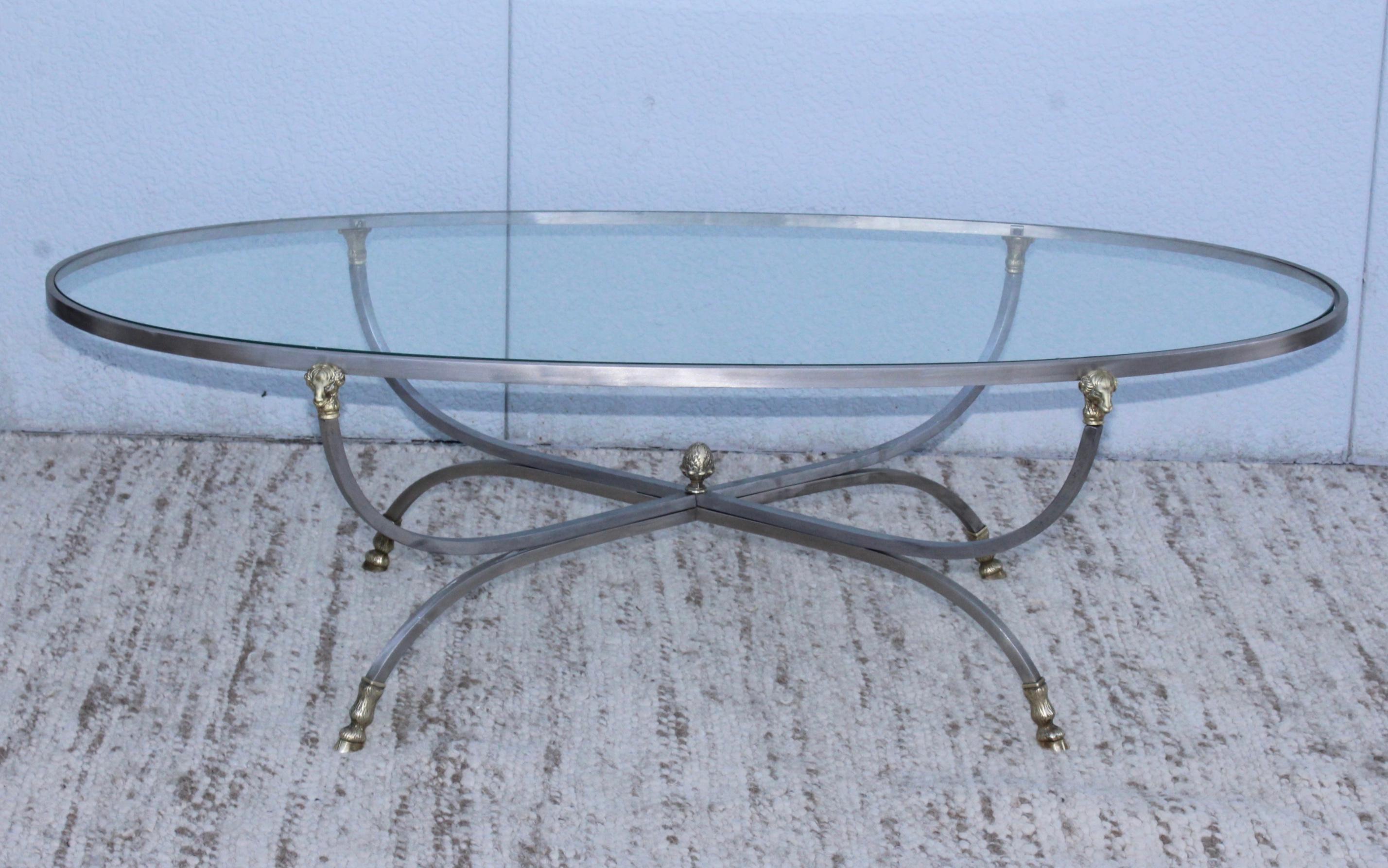 1960s modern steel frame with brass ram's head and feet oval coffee table, in vintage original condition with minor wear and patina due to age and use.