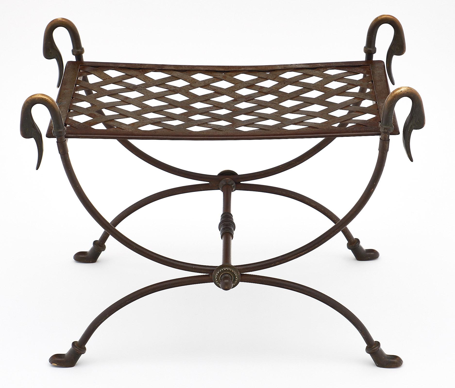 Bronze and steel antique swan stool. This French piece is made of hand-hammered steel with bronze legs and bronze swan necks. We love the elegant curves of the Curule shape.