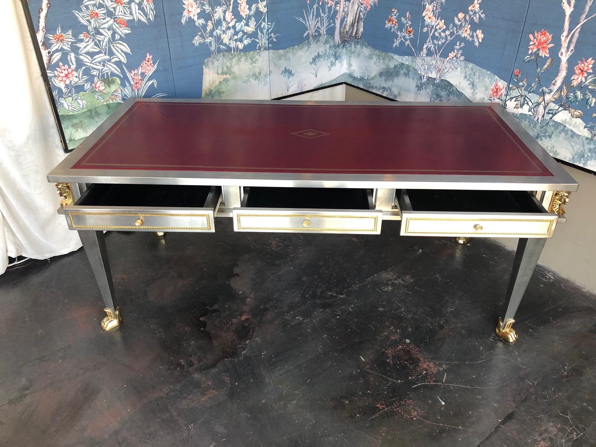 Stainless steel and bronze desk. With red leather top. By John Vesey.