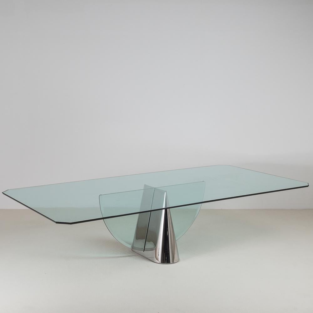 A polished dining table base with a polished steel conical, bisected with a bevelled semicircle glass, titled 'Pinnacle' designed by Jay Wade Beam for Brueton, 1970s

Photographed with a 3 metre glass top, dimensions of stock glass included to be