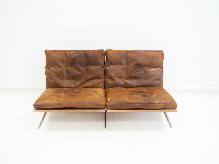 Minimalist L-shaped sofa in brushed steel and brown leather designed by Preben Fabricius & Jørgen Kastholm. This model BO562 sofa was produced in Denmark by Bo-Ex in the 1960's. Very comfortable seat. The leather upholstery is in fair condition,