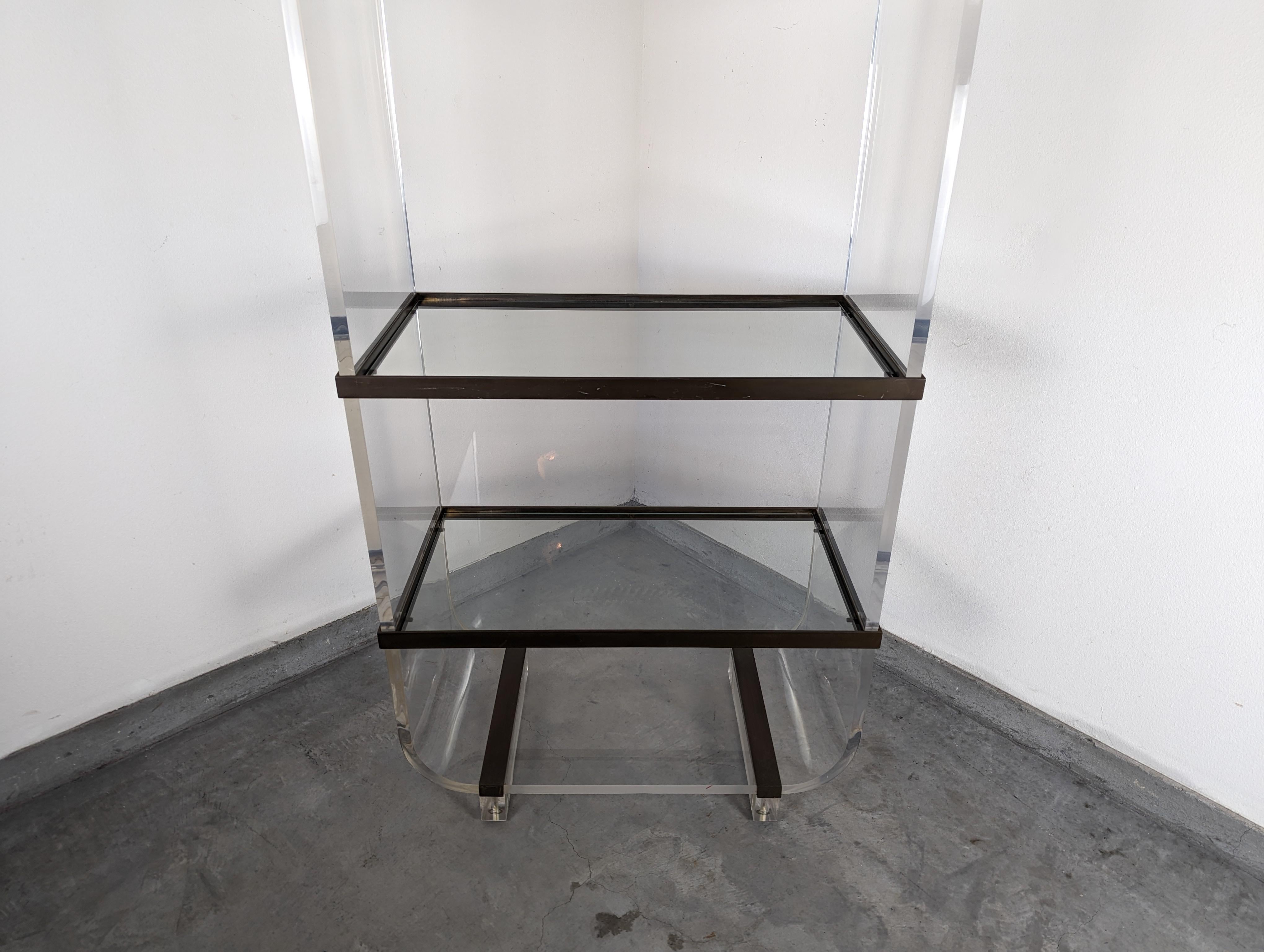 Step into the epitome of vintage glamour with this remarkable postmodern Lucite etagere, attributed to the iconic American designer Charles Hollis Jones, renowned for his pioneering work with acrylic and Lucite in the 1970s. This exquisite piece,