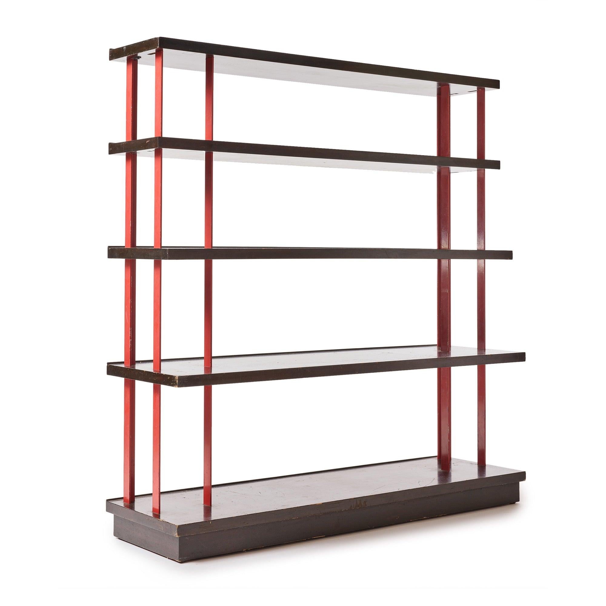 A beautiful solid mahogany 5 shelf bookcase with steel vertical flat bars finished in red lacquer.?all finishes are original and are in fine condition with a few touchups.