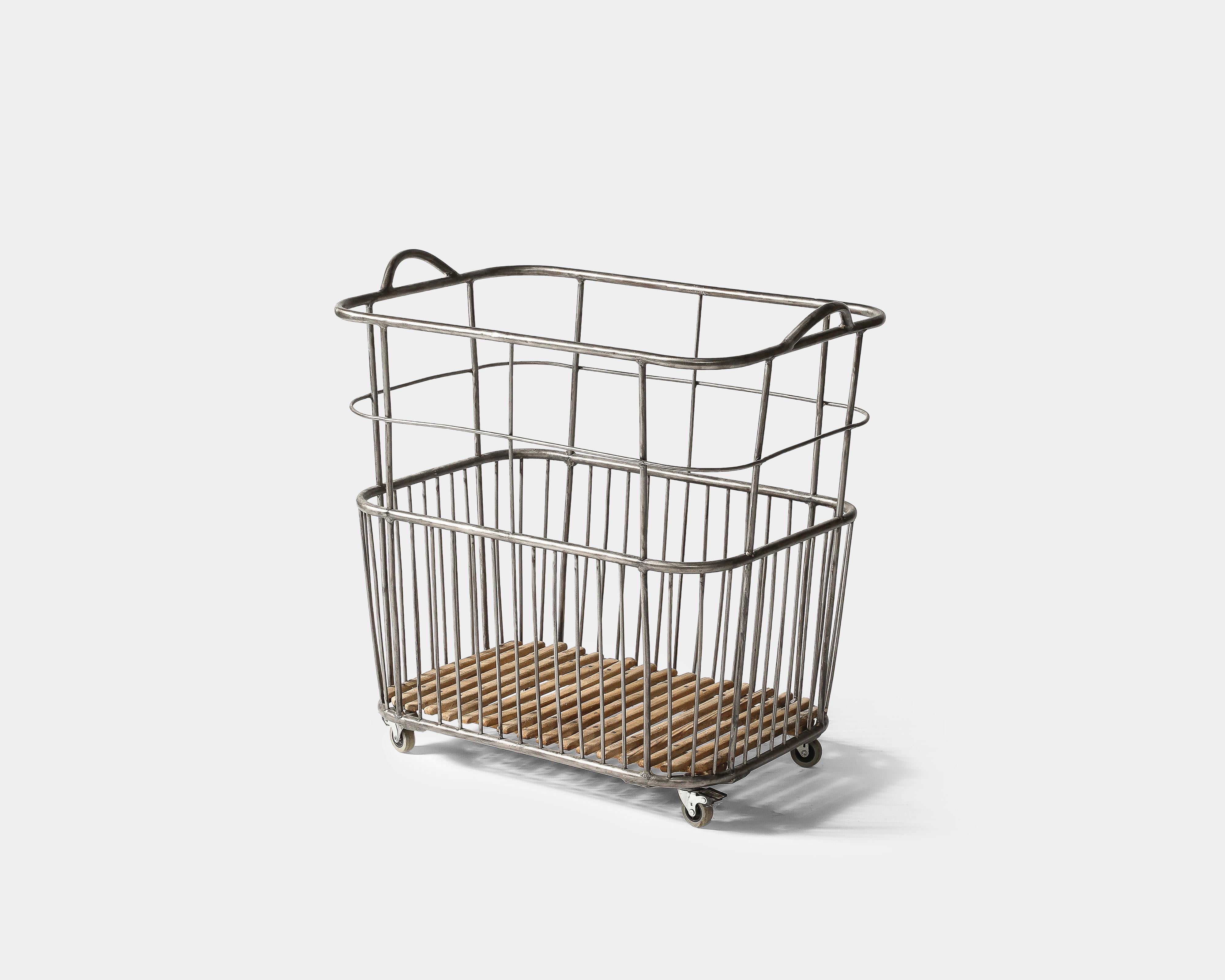 Rolling French basket, with a steel frame, wood slats at the bottom, and four bolted casters. This is in good vintage condition; this rolls easily, albeit somewhat shakily. The wheels could be adjusted if desired.